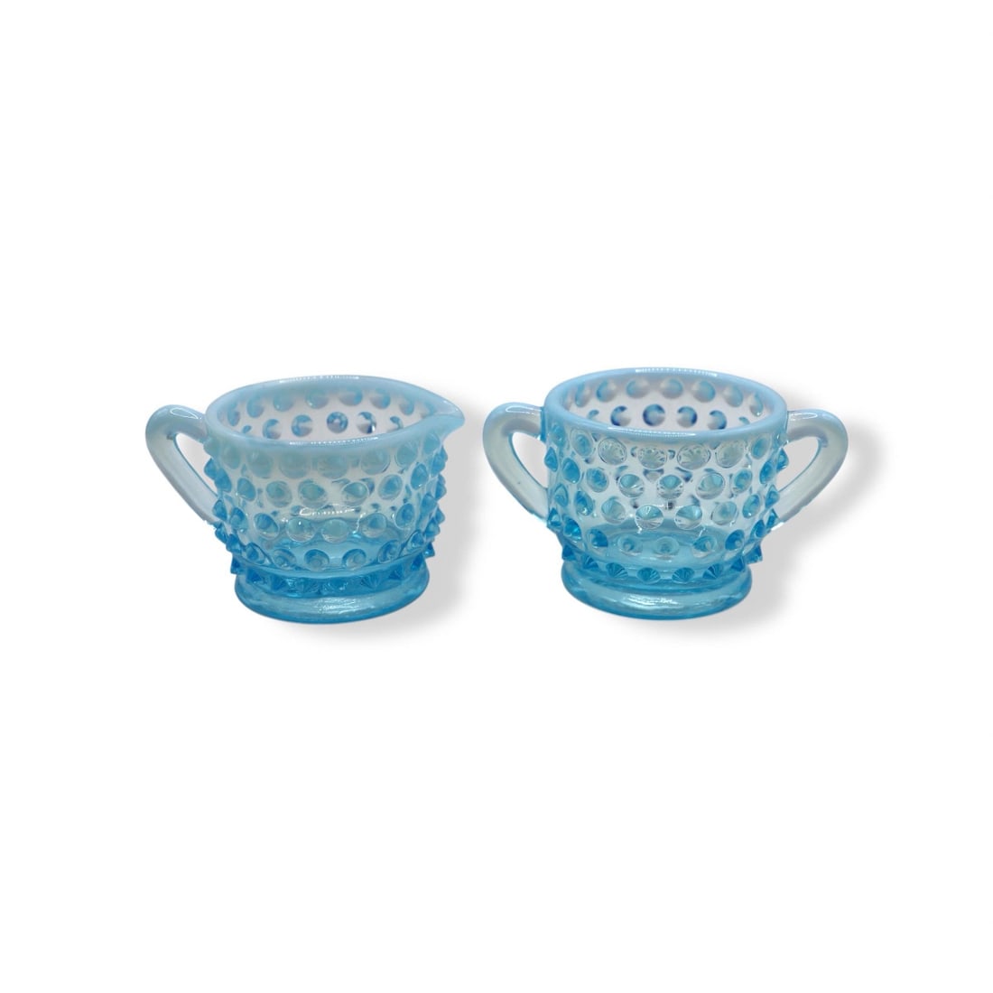 Fenton Art Glass Blue Opalescent Hobnail Small Open Sugar & Creamer: Fenton Art Glass Blue Opalescent Hobnail open sugar and creamer measuring 2 inches tall and showcasing the iconic hobnail pattern, complemented by opalescent blue glass that shimmers beautifully in th