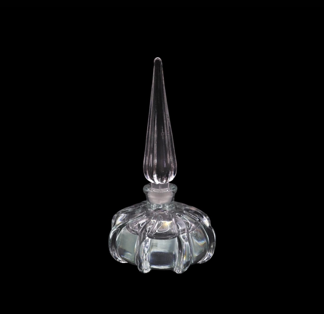 Vintage Heavy Lead Crystal Clear Perfume Bottle w/ Pointed Stopper: This vintage perfume bottle is a beautiful addition to any collection. Made from heavy lead crystal, it stands at 7 inches tall and features a pointed stopper. The bottle is clear, allowing the conten