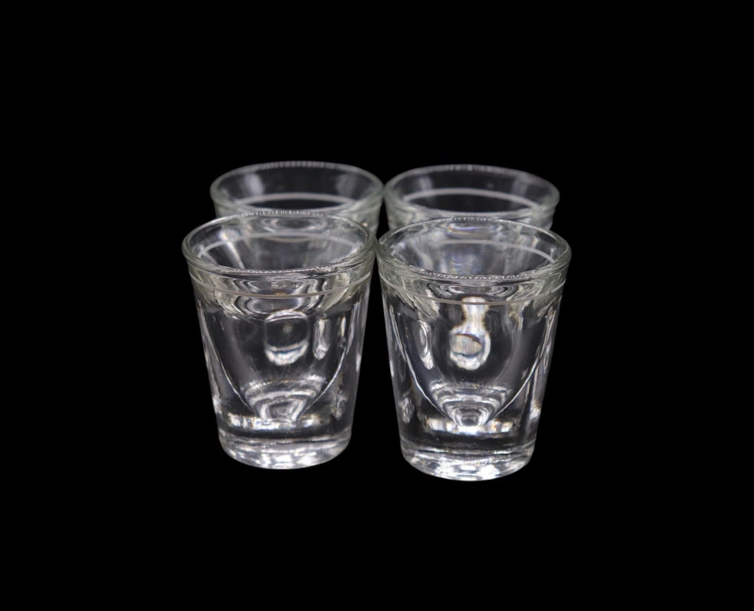 (4) Vintage Mid-Century Modern Style Clear Glass Shot Glasses: Set of 4 vintage mid-century modern-style clear glass shot glasses, each standing 2 1/4 inches tall. These pieces feature a sleek, minimalistic design with a subtle white line and dot detail around th