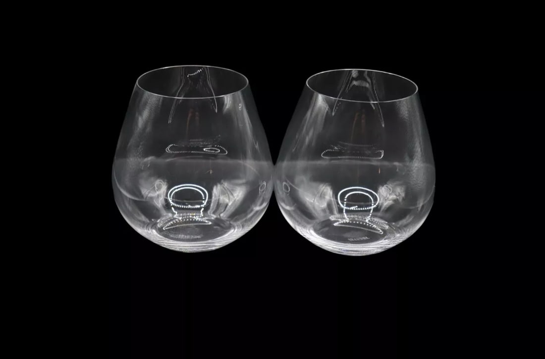 Pair of Riedel Crystal “O” Pinot Nebbiolo Wine Glasses: Pair of Riedel Crystal “O” Pinot Nebbiolo Wine Glasses showcasing a sleek, stemless design, blending contemporary style with functionality. Standing 4 1/2 inches tall, these elegant glasses ar