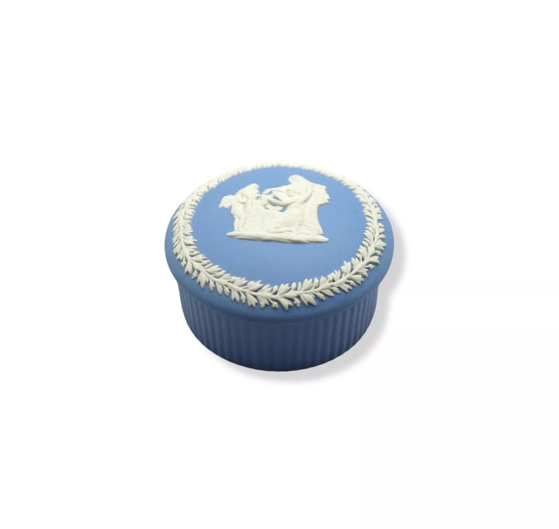 Wedgwood Cream Color on Pale Blue Jasperware 2” Round Fluted Box & Lid: Wedgwood Cream Color on Pale Blue Jasperware Round Tray, showcasing intricate relief of vines and Cupid as the oracle. Measuring 2 5/8 inches wide, this elegant piece is in excellent condition. A time
