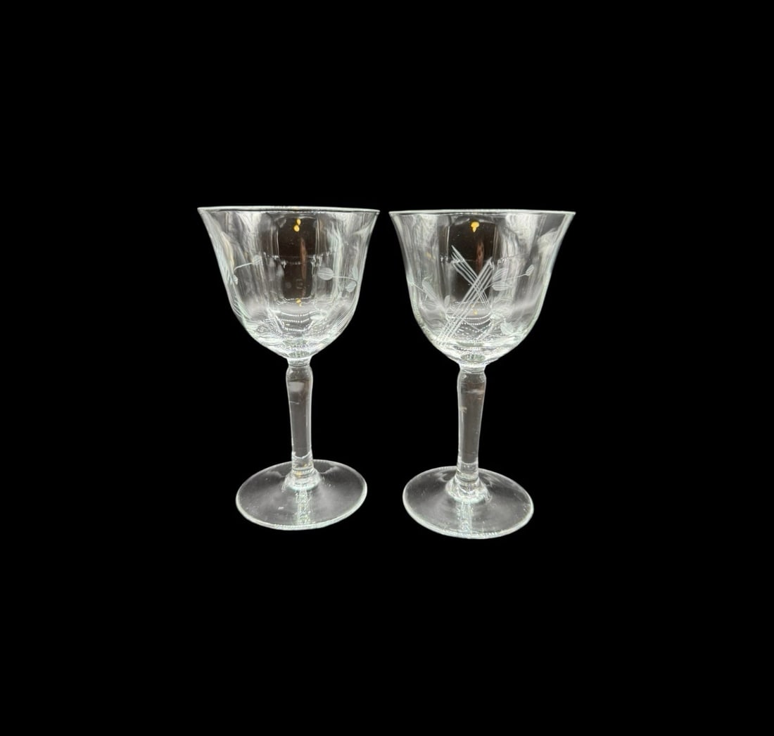 Pair Of Vintage Etched Wine Glasses: This pair of vintage etched wine glasses hails from the 1930s with a floral theme design, making them perfect for all occasions. The clear glass gives them an elegant and timeless look, while the etch