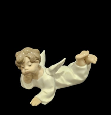 Lladro Figurine ' Angel Laying Down": Lladro Figurine ' Angel Laying Down". 5" x 6" x 3.5" In-house shipping is available for smaller items. Shipping is available for larger and other fragile items through Pac Mail, which is a local