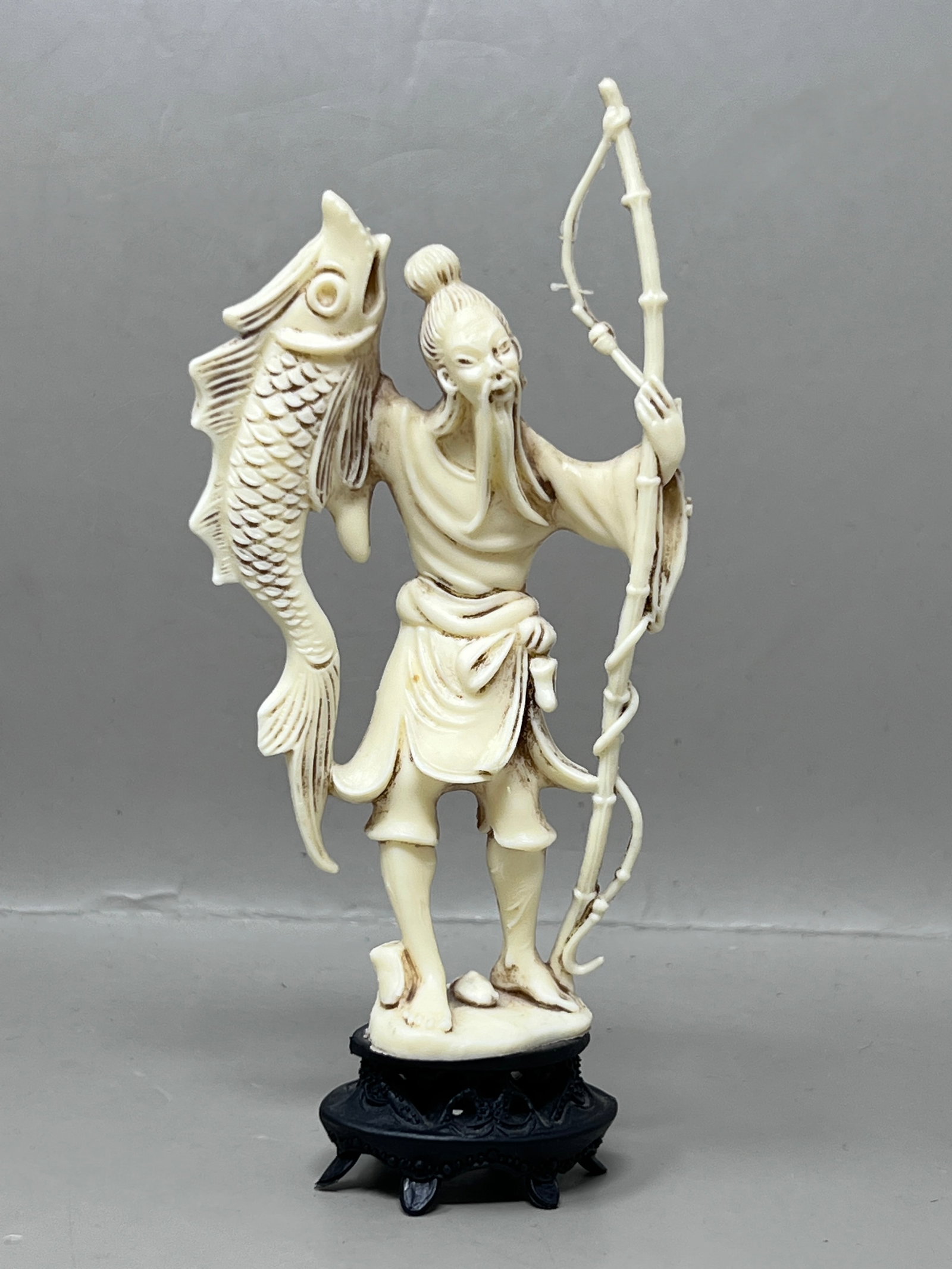 Vintage Resin or Plastic Figurine of Asian Fisherman: lightweight and safe figurine for homes with pets