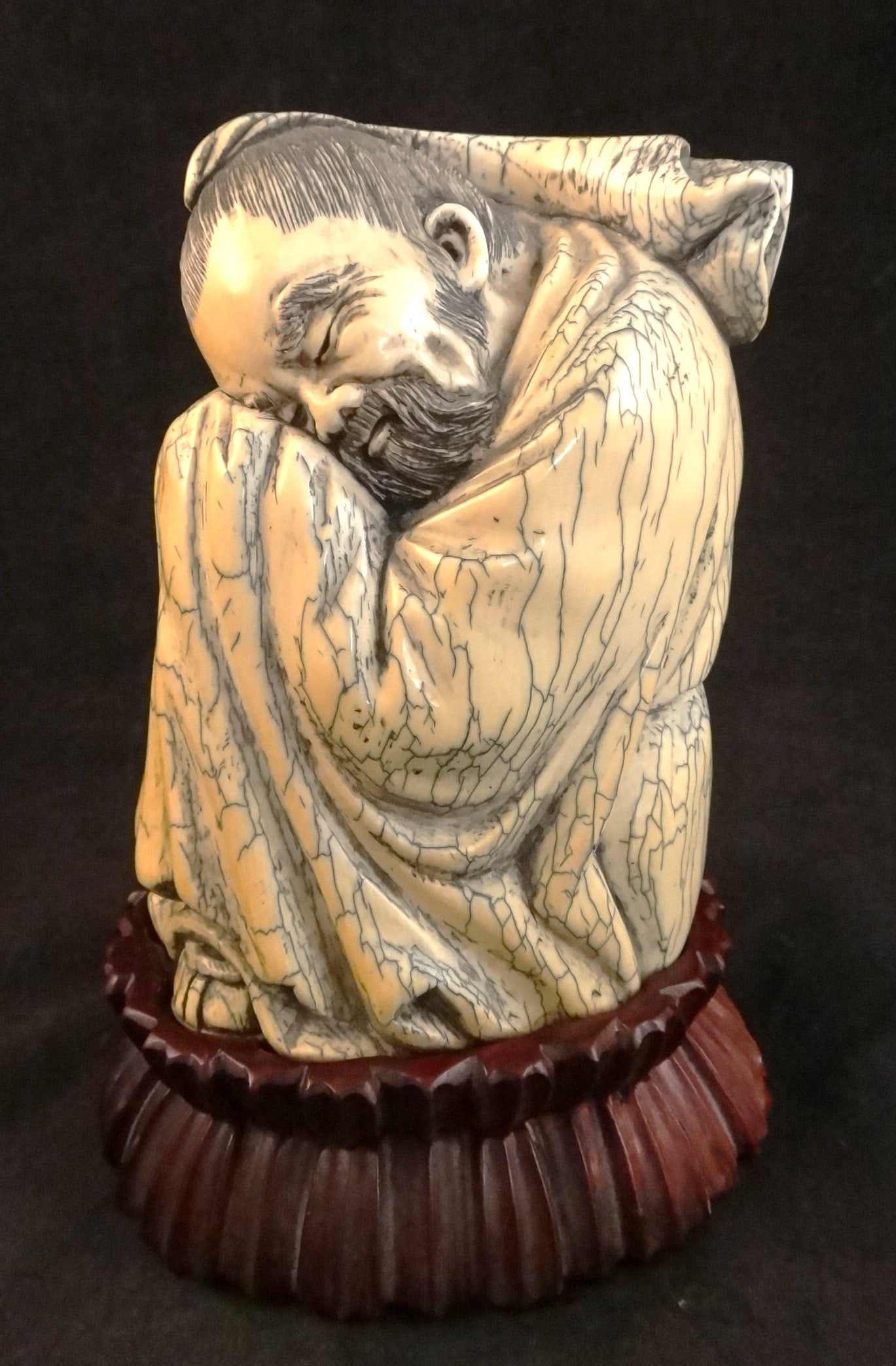 Ancient Mammoth Tusk - Carved Buchan Figure: Ancient Beautifully Carved Mammoth Tusk. Features seated asleep Buchan with Apocryphal Chenghua mark. Custom carved wood stand. Figure measures 5” tall, 4” wide x 3” deep, 925 grams.