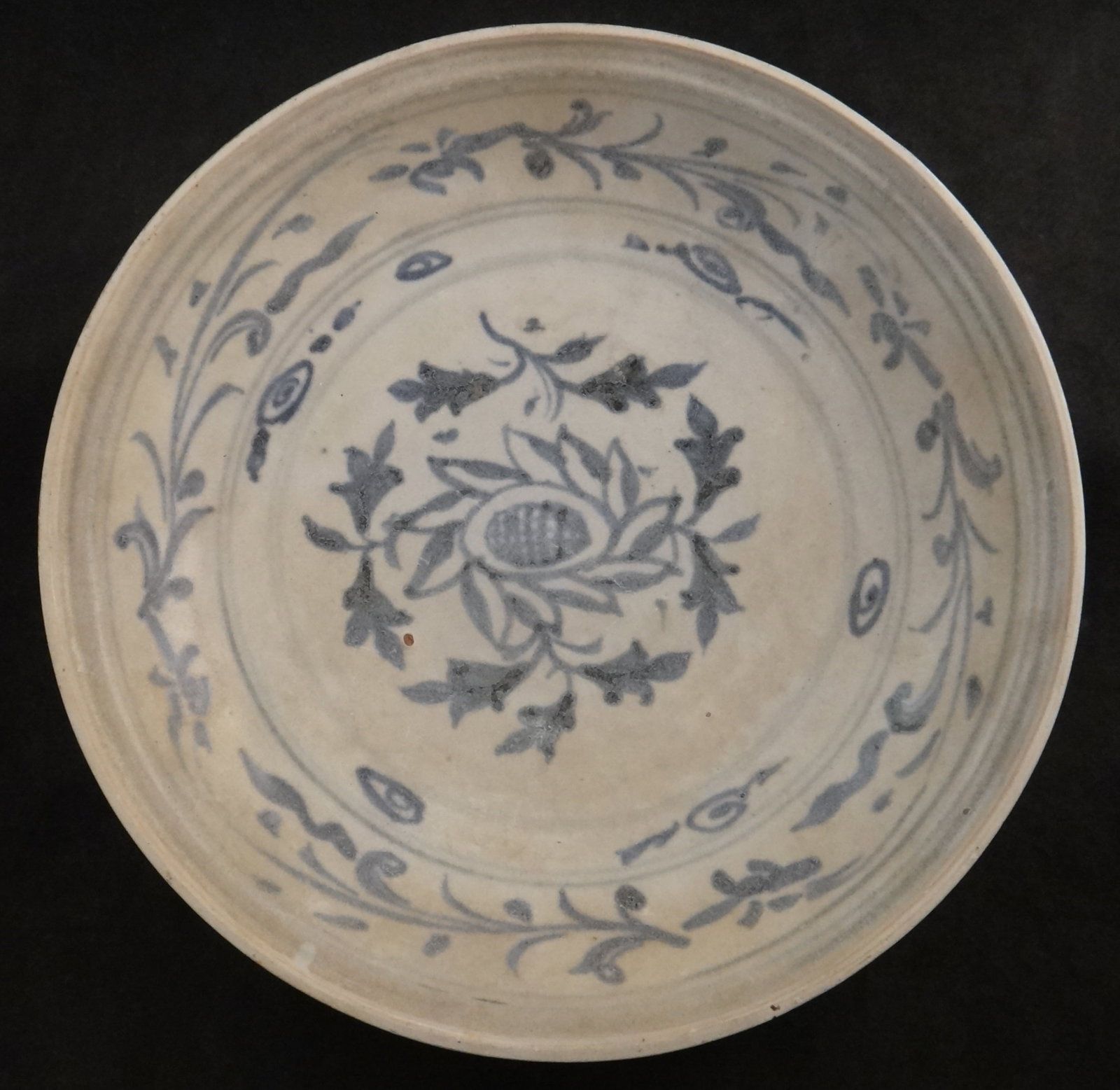 Ancient 15th cent. Hoi An Hoard Porcelain Footed Bowl: Ancient 15th cent. Hoi An Hoard Porcelain Footed Bowl w/nicely painted floral designs. 9 ½” dia. x 2” tall. Circa 1475-1500. Both stickers attached to the bottom.