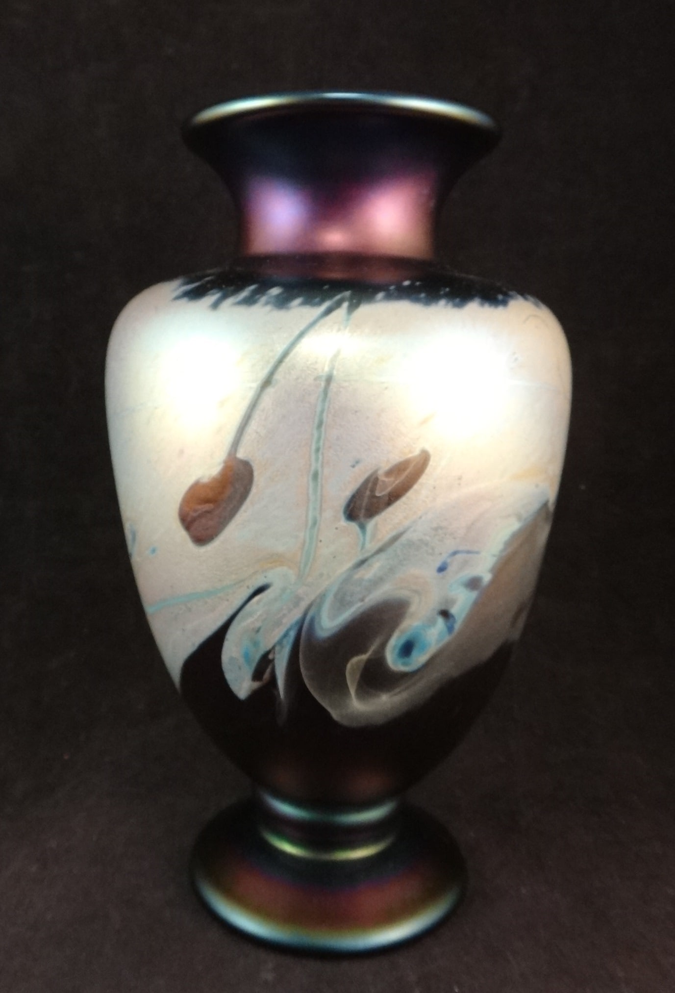David Tate 1990 Art Glass Vase: David Tate 1990 Art Glass Vase in the tiffany Style with beautiful iridescent colors on a deep blue iridescence ground. 8 ¾” t. x 5” dia. Etched on the bottom D. Tate 90.