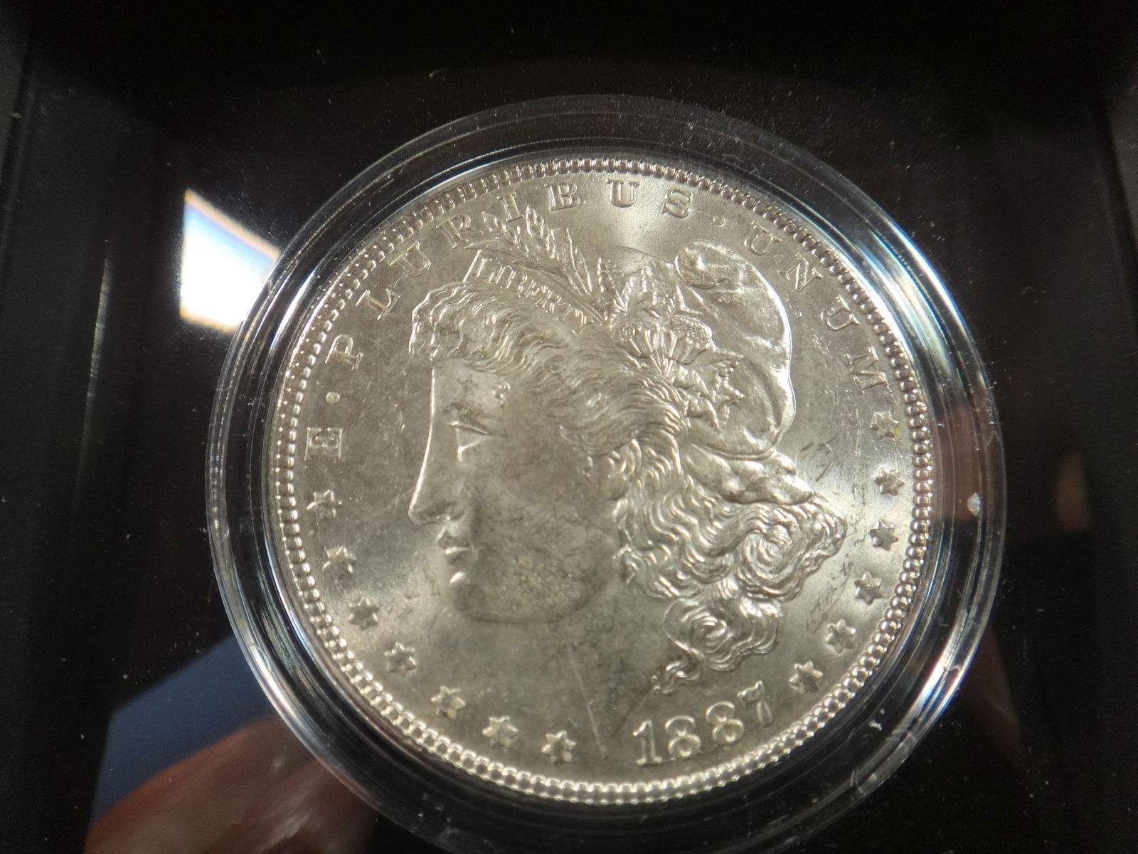 1887 P Morgan Silver Dollar with Nimbus Frame, Gem B.U.: 1887 P Morgan Silver Dollar with Nimbus Frame, Gem B.U.