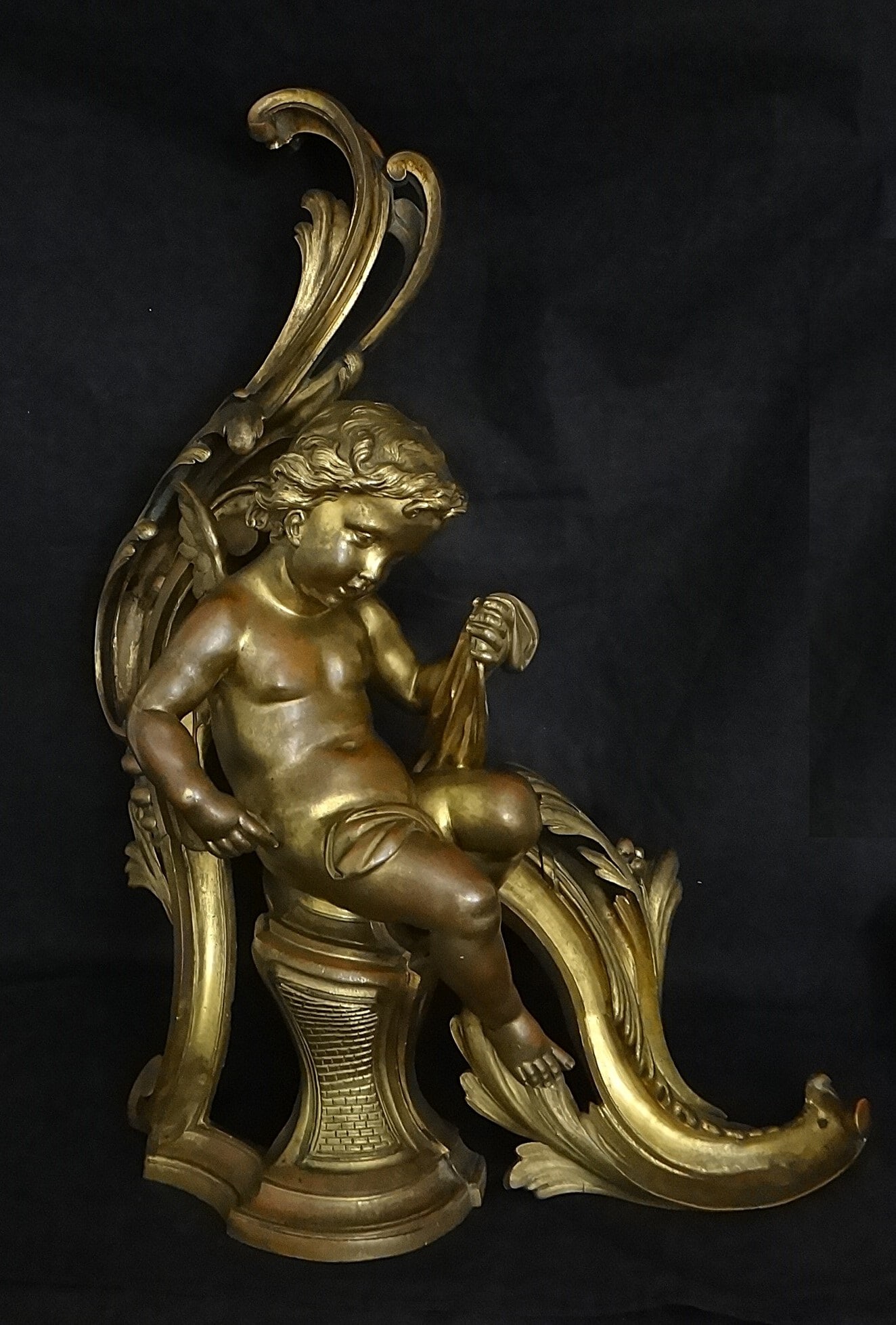 Large Antique French Napoleon III Gilt Bronze Chenet w/Cherub: Large Antique French Napoleon III Gilt Bronze Chenet with Cherub in a Rococo Leaf Form. Circa 1860’s. 20” tall x 16” wide x 7” deep. Heavy at 21 lbs. 3oz. Modern iron support beam.
