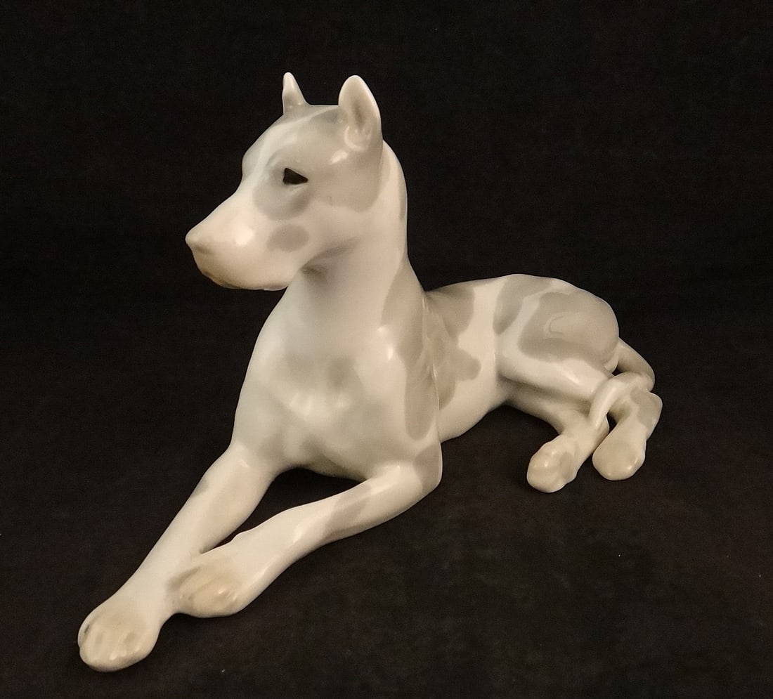 Vintage Lomonusov Porcelain Great Dane: Vintage Lomonusov Porcelain Great Dane painted with gray spots on white. Mid-20th cent. 9 ½” long x 5 ½” tall x 4” deep.