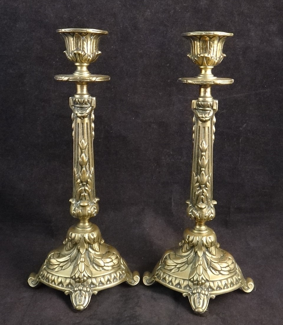 Pr. Antique European Solid Brass Renaissance Revival Candlesticks: Pair of Antique European Solid Brass Renaissance Revival Candlesticks with tapered columns & floral motifs. 19th cent. 9” tall x 4” wide. Old store price tag on bottom – purchased for $8
