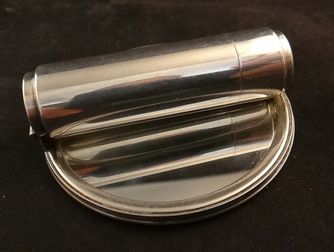 Mid-c. Sterling Silver Lipstick & Mirror Compact with fold down handle.: Mid-cent. Sterling Silver Lipstick & Mirror Compact with fold down handle. The lipstick pulls out of the handle. 2 ¼” dia. mirror, 53.6 grams total wt. Engraved initials on cover.