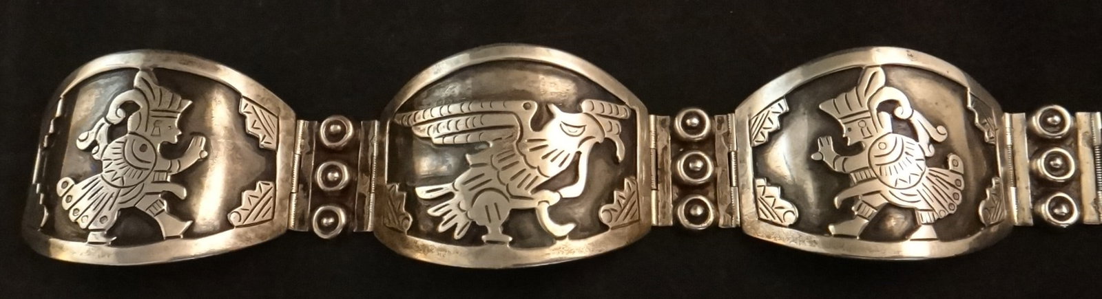 Mid-c. Mexican Sterling Bracket with Eagle Center & Warriors: Mid-cent. Mexican Sterling Bracket with Eagle Center & Warriors on each side. Stamped Mexico Sterling, 45.7 gr, 6 ¾” long, approx. 2 ½” inside dia. when closed.