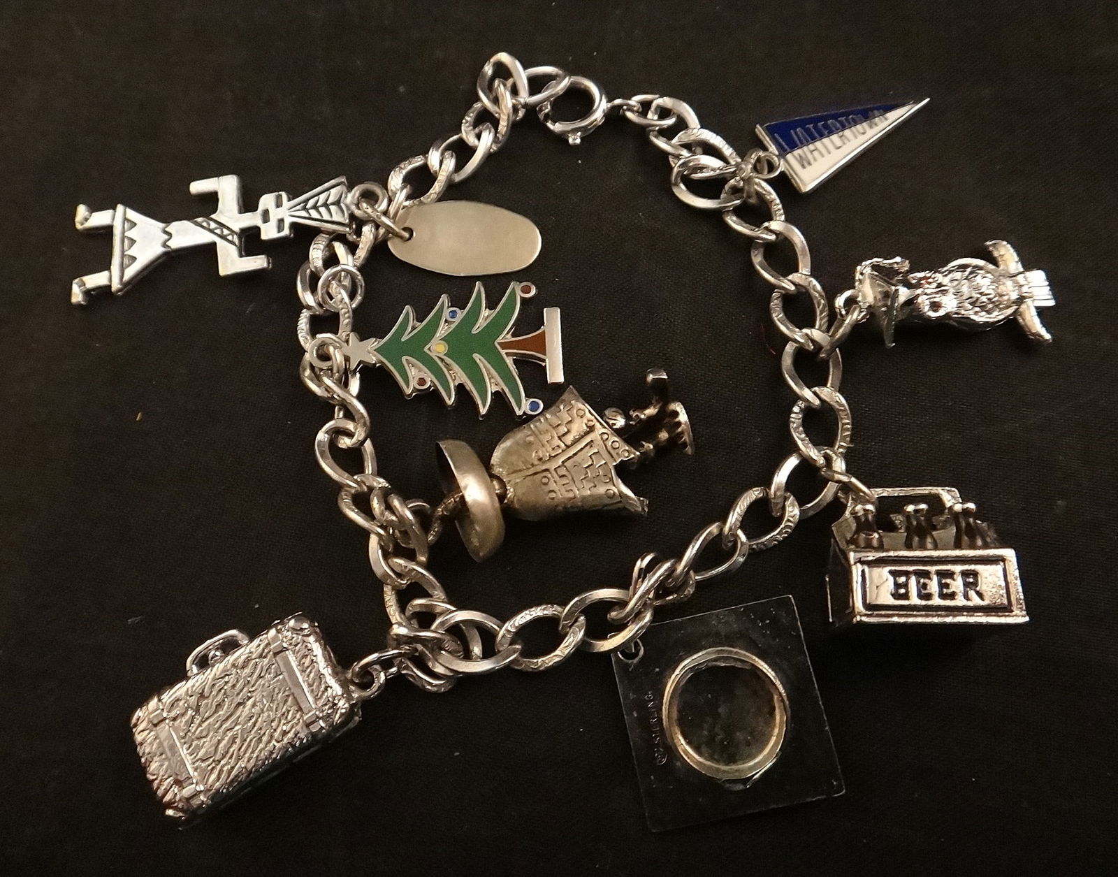 Vintage Sterling Charm Bracelet w/8 Sterling Silver Charms.: Vintage Sterling Charm Bracelet with 8 Sterling Silver Charms. 2 marked Wells Sterling, one Mexican 925, one New Mexico, others Sterling. All tested. 7 ½” long.