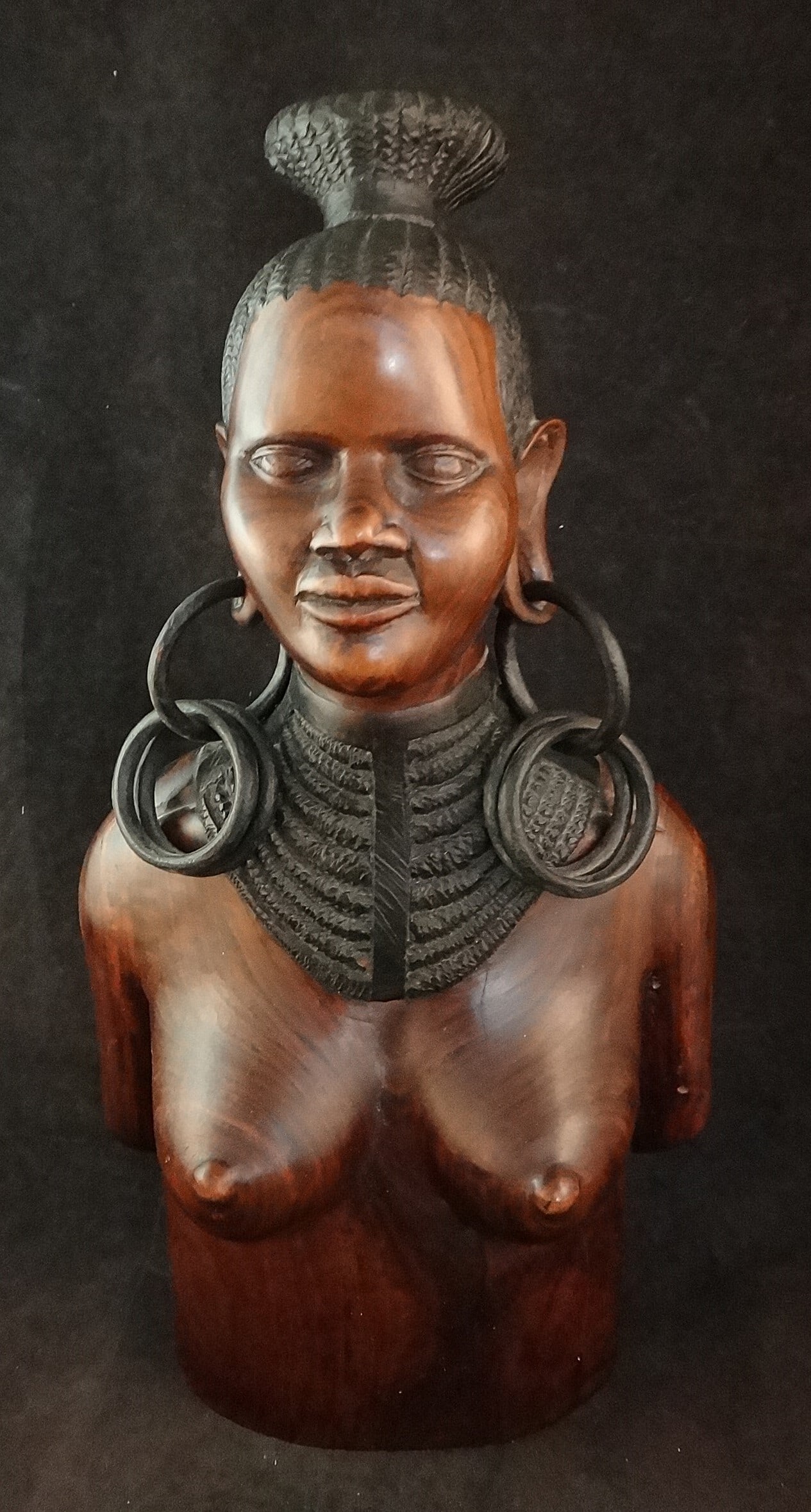 Lg. vintage African Finely carved rosewood female figure: Large vintage African Finely carved rosewood female topless figure with coiffed hair, 9 strand necklace & loose ring earrings. 20th cent. Measures 15 ½” tall x 8” wide x 4 ½&