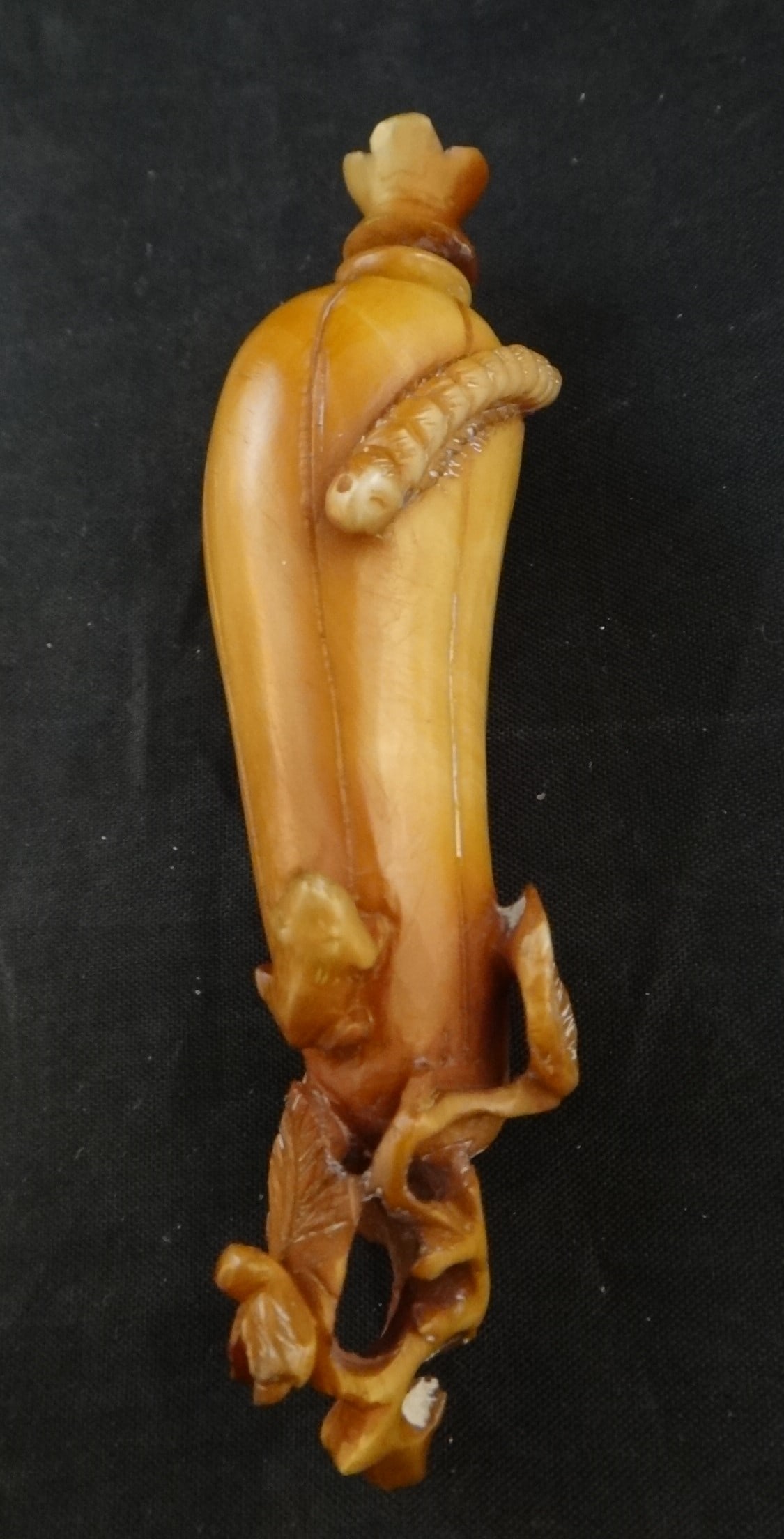 Antique Chinese carved eggplant snuff bottle,: Antique Chinese carved eggplant snuff bottle, Features vines & leaves, frog & moth. Late 19th C. Measures overall 3 3/8” long x ¾” wide.