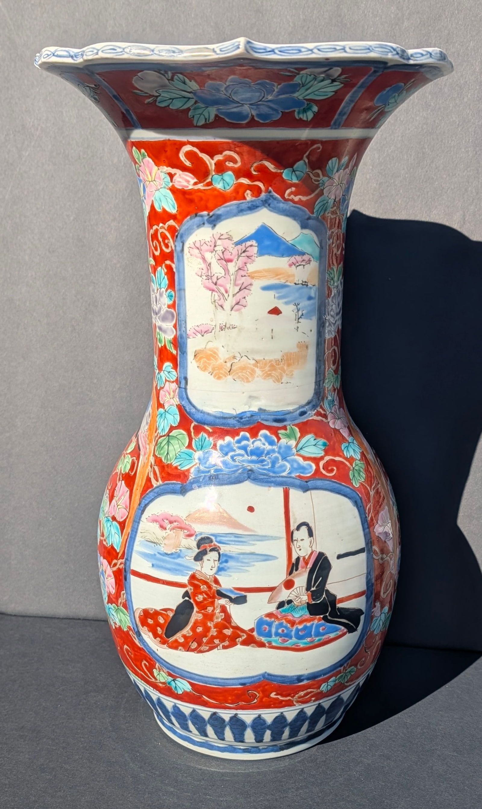 Lg. Antique Japanese Arita Porcelain Vase w/Floral, People & Mt. Fugi.: Large Antique Japanese Arita hand-painted porcelain vase with a decoration on each side of a man and woman in a building overlooking Mount Fuji. Overall floral design around the scenes. Meiji period