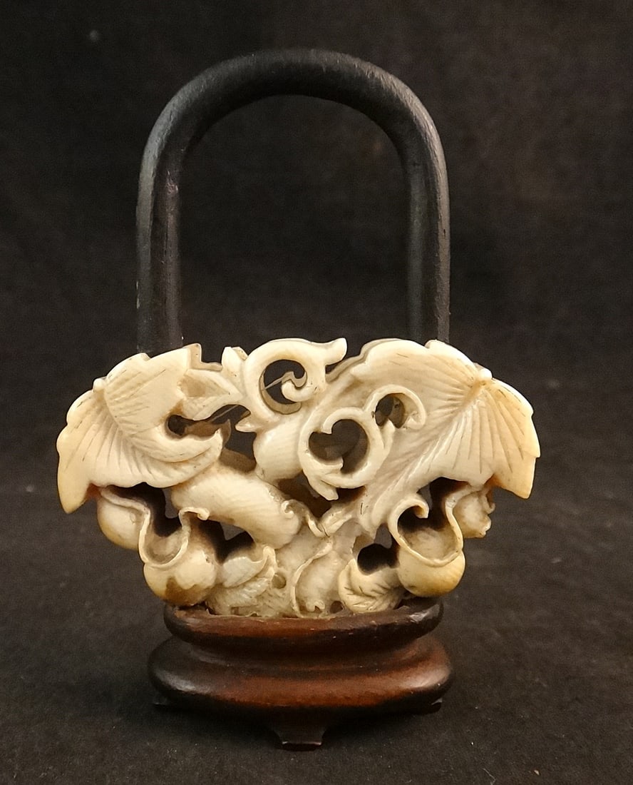 Antique Chinese Carved Fan Ornament in the form of a Flower Basket: Antique Chinese Carved Fan Ornament in the form of a Flower Basket on a later rosewood stand with 4 feet & wood handle. Overall measures 2” wide x ½” deep x 3” tall.