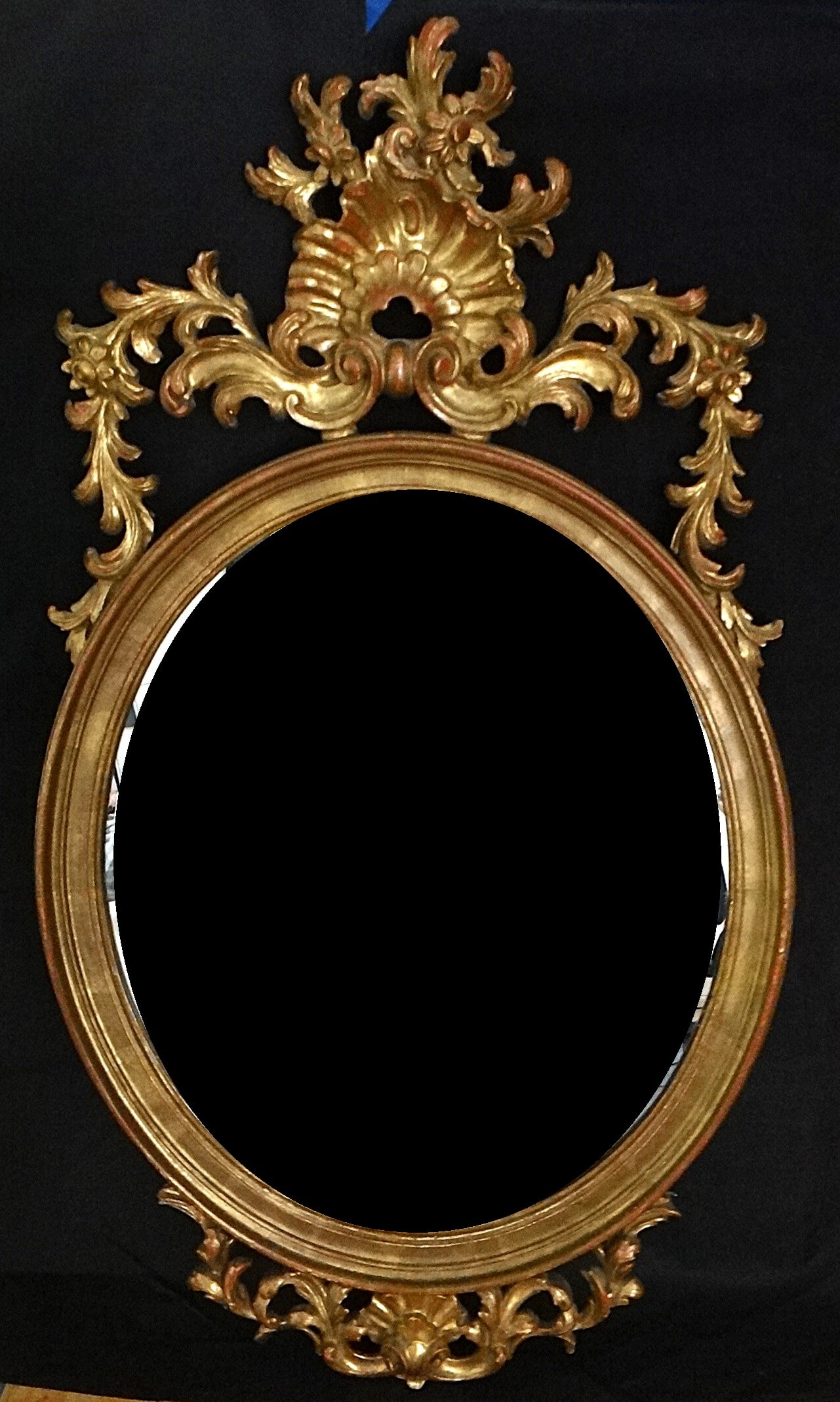 Antique Italian Rococo Design Oval Gold-leafed Wood Mirror.: Antique Italian Rococo Design Oval Gold-leafed Wood Mirror. Late 19th/Early 20th c. 39” ht. X 23" wide.