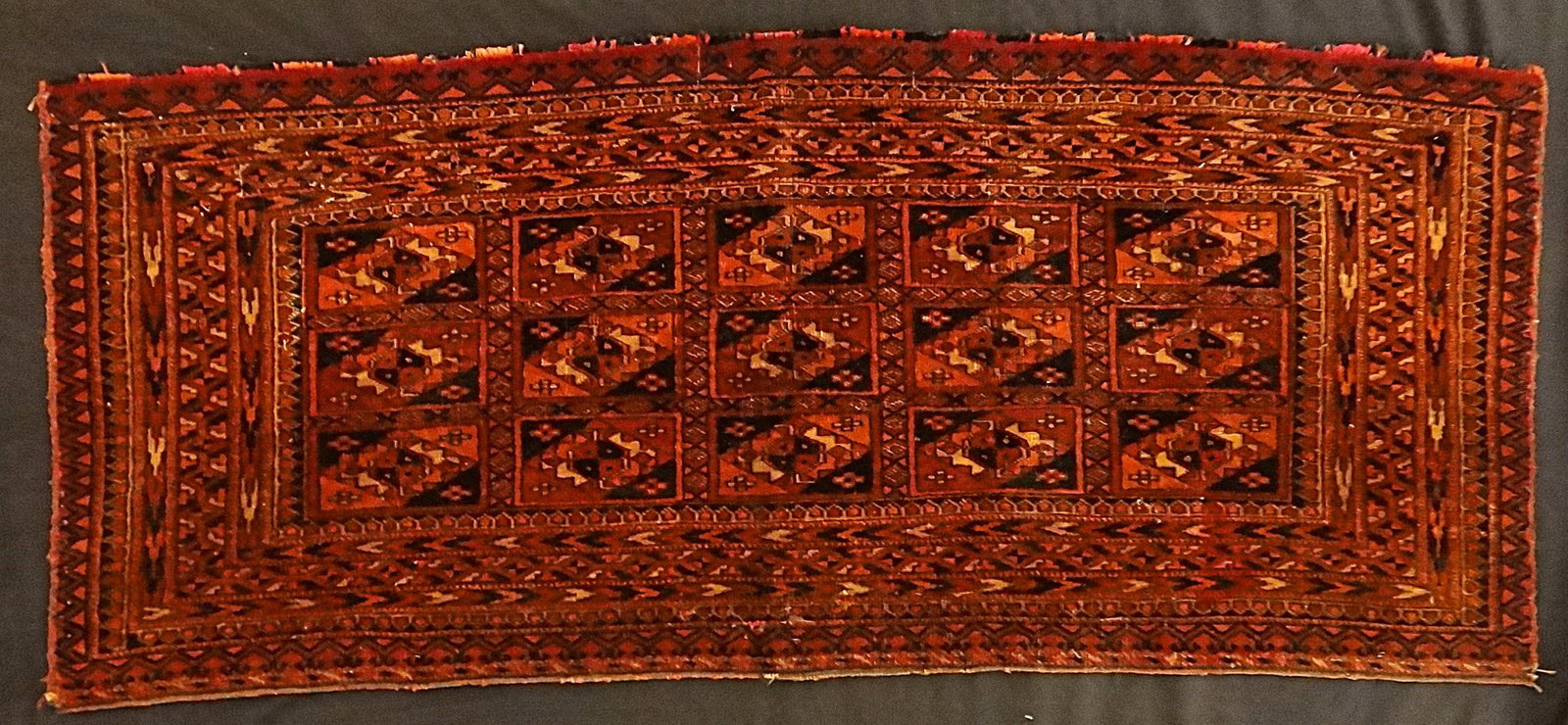 Antique Turkoman Tekke Hand Knotted Wool Bag Face Rug: Antique Turkoman Tekke Hand Knotted Wool Bag Face with 3 Rows of Tribal Guls. Late 19th cent/early 20th cent. Measures approx. 38 ½” x 16 ¼”.
