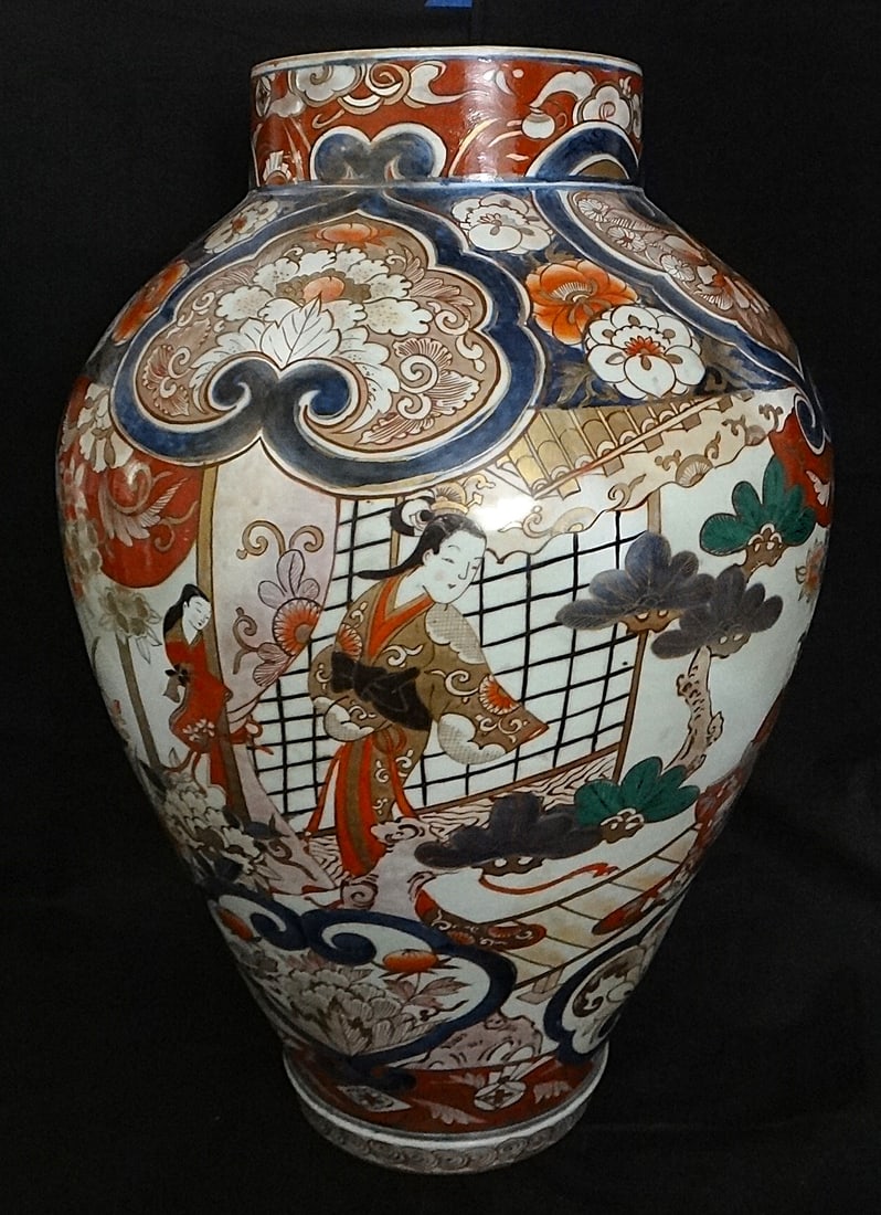 Early 18th c. Massive Japanese Arita/Imari Vase, Woman Garden Motif: Early 18th cent. Massive Japanese Arita/Imari Vase with a design of woman in a garden setting. Floral designs surround the continuous scene. 24” tall x 16” dia. Weighs 26lb 8oz. No lid. Lo