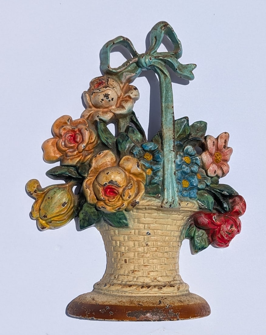 Lg. Antique Hubley Floral /Basket Iron Door Stop: Lg. Antique Hubley Beautifully Hand Painted Iron Door Stop, #121, of a Floral Arrangement in a Basket with Bow. Circa - Early 20th C. 10 3/4" tall x 8" wide x 2" deep. Heavy at 5 lb 13 oz.