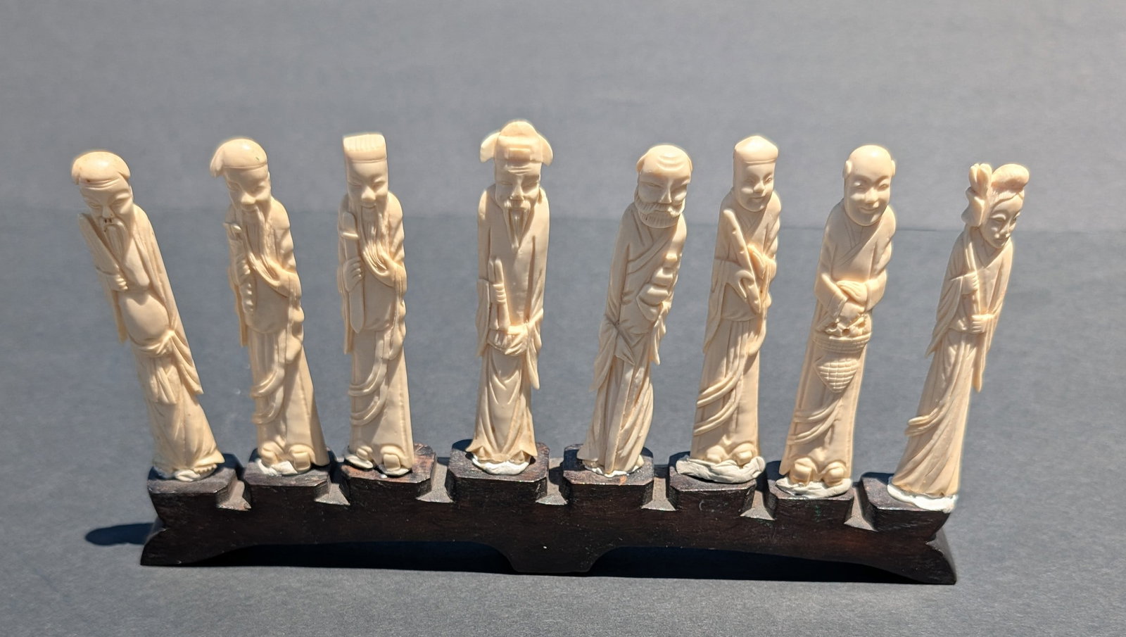 8 Antique Chinese Carved Immortals on a Carved Tiered Stone Stand: Set of Antique Chinese Carved 8 Immortals on a Carved Tiered Stone Stand - 9 3/4" long. Each Immortal is approx. 3 3/4" tall. Late Qing dynasty - 1860-1912.