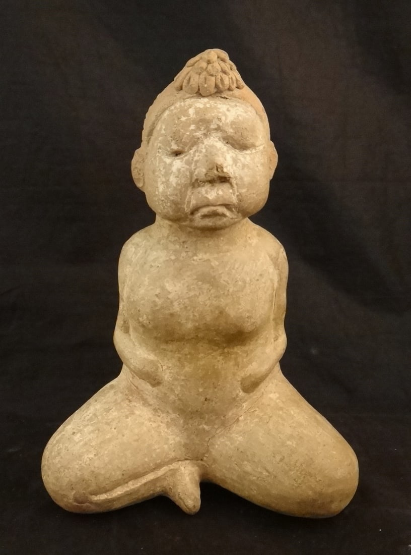 Ancient Pre-Columbian Olmec Pottery seated female Figure: Rare Ancient Pre-Columbian Olmec Pottery seated female Figure wearing a hair band with flower. Circa 500 B.C.E. 7” tall x 5” wide x 3 ½” deep. Original holes behind arms for h