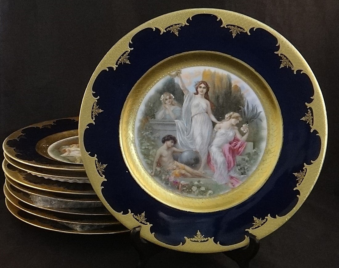 8 Hutschenreuther HP Porcelain Cabinet Plates w/Heavy 23k gold trim.: Set of 8 Hutschenreuther Hand Painted Porcelain Cabinet Plates. 11” dia. 23k gold trim. Early 20th cent. Royal Vienna Underglaze Blue Beehive marks on the bottoms.