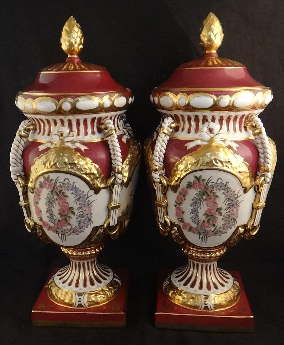 Pr. 19thc. French Porcelain Covered Urns w/4 panels, 2 frontier life.: Pair of French Porcelain Covered Urns with 4 panels on each, 2 depicting frontier life. 19th cent. 16 ½” t x 6 ½” w. Base is 5 ¼” sq.
