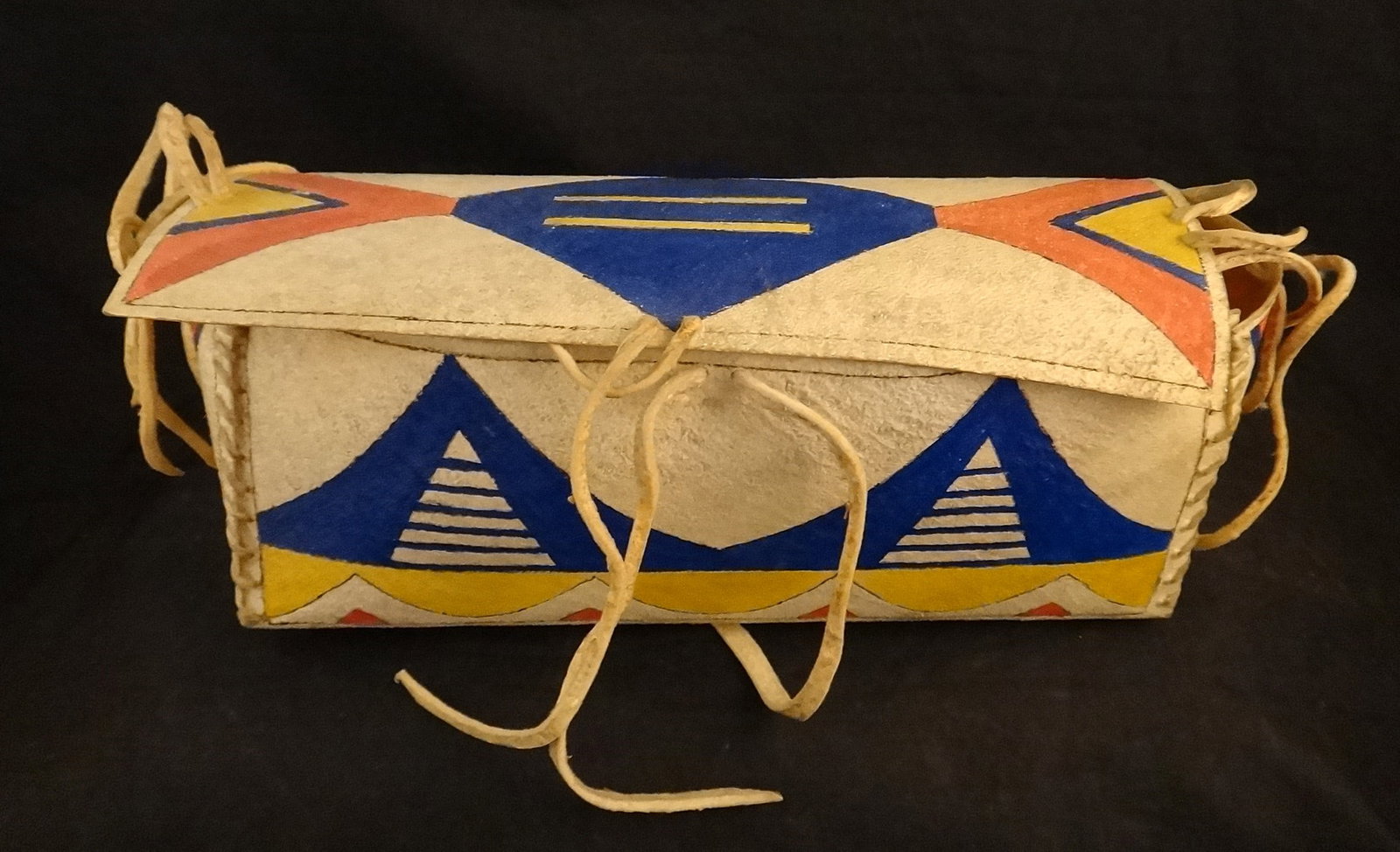 Antique Native American Souix -Par Fleche- rawhide leather container: Antique Native American Souix Indian “Par Fleche” stitched rawhide leather container with finely painted geometric designs in blue, red & yellow. Late 19th/early 20th cent. 9” wide x 3 &
