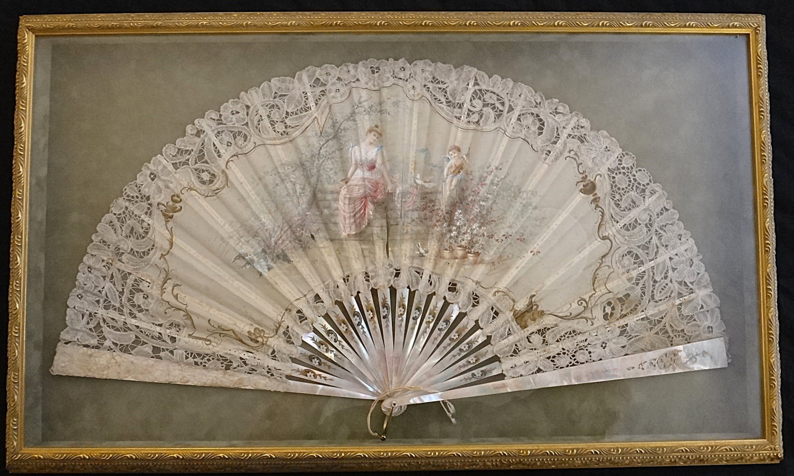19th c. French Folding Fan by Marcel Porchet - beautiful woman: Large 19th c. French Folding Fan by Marcel Porchet with finely painted center scene on silk of a beautiful young woman with cherub playing the violin & 2 white doves. Mother of pearl sticks with pierc