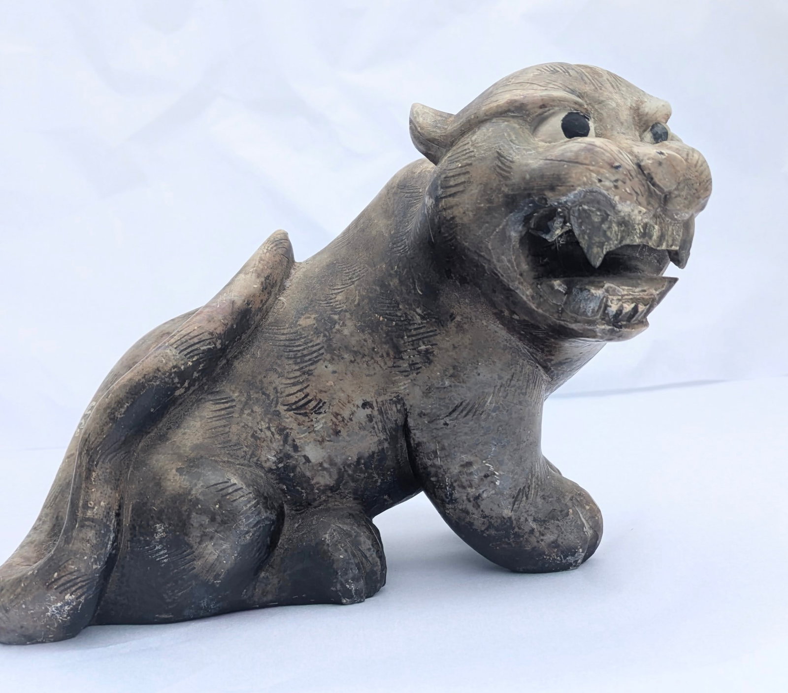 Antique Chinese Carved Stone Growling Cat. 19th cent: Antique Chinese Carved Stone Growling Cat with fierce look & painted black eyes. 19th cent, Qing Dynasty. 8” long x 5 ½” tall x 4” deep. Weighs 5lbs, 3.5 oz.