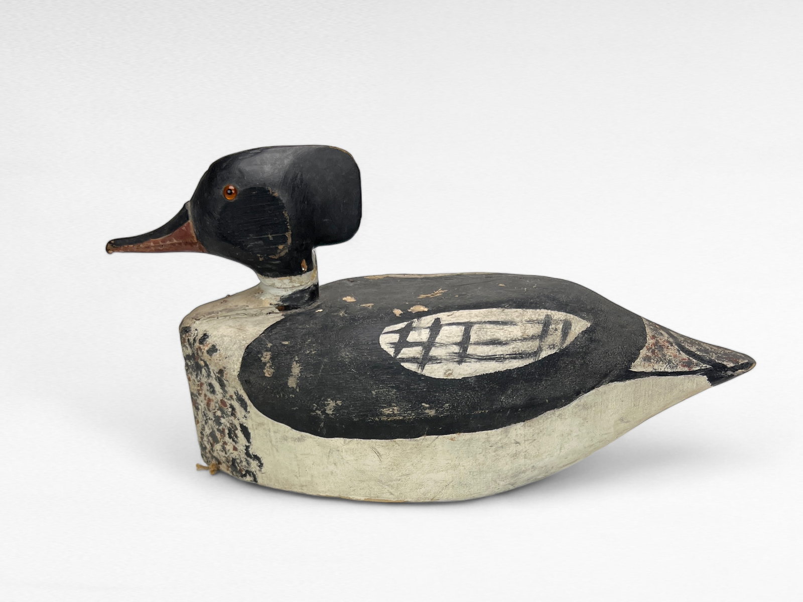 Merganser Drake: Virginia, c.mid 20th century17" longHigh body folky merganser drake appearing to have originated on the Eastern Shore. Large balsa wood body with an applied hard wood head. Deeply carved bill detail, 