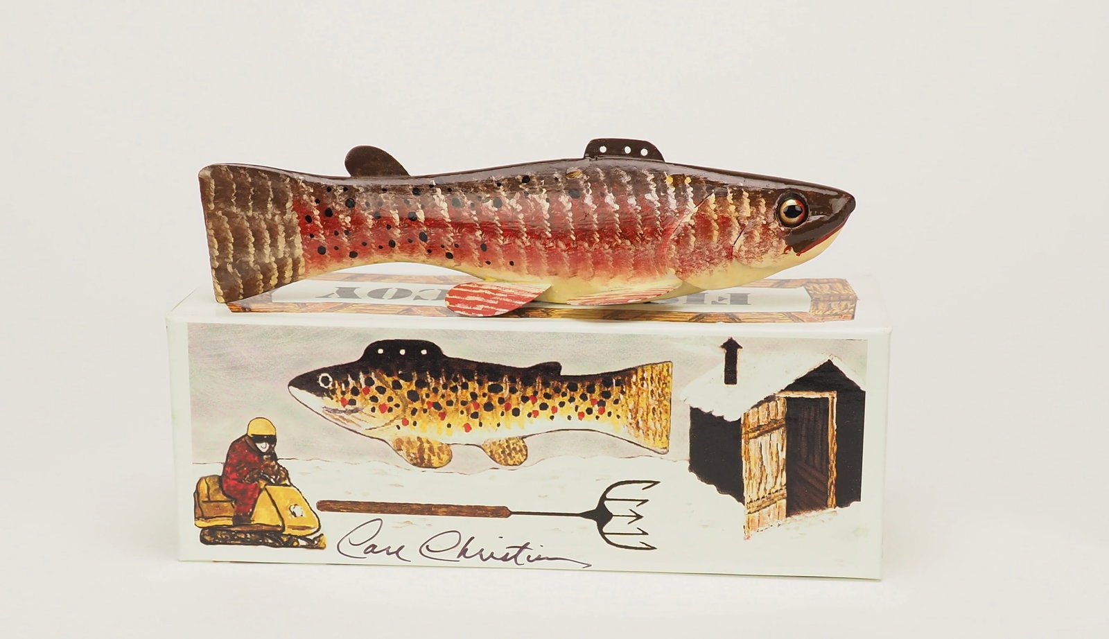 Canadian Red Spear Fishing Decoy - Carl Christiansen: Carl ChristiansenNewberry, MI5.75" longHollow carved wood with an inserted rattle with glass eyes and metal fins. Signed by the maker. Comes with the original boxLot 264 through 290 are a complete set