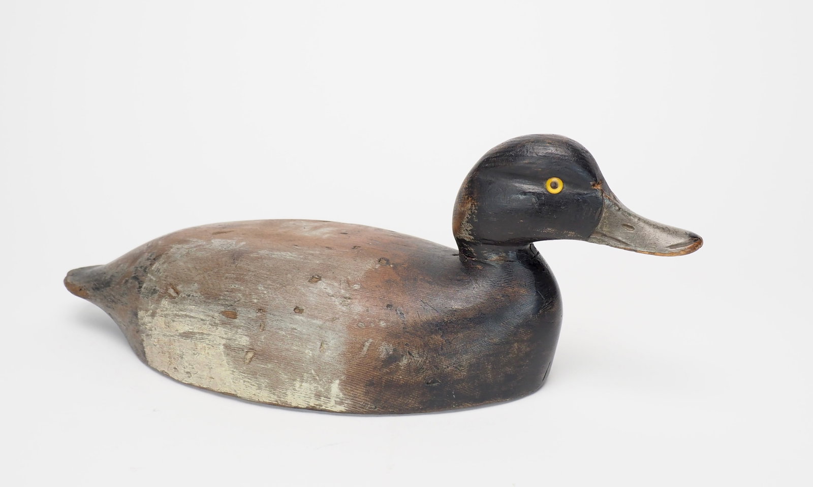 Bluebill Drake - Chauncey Wheeler: Chauncey Wheeler (1888-1945) Alexandria Bay, NY 16" long Working bluebill drake with honest wear. Carved bill details with cut eye grooves and glass eyes.