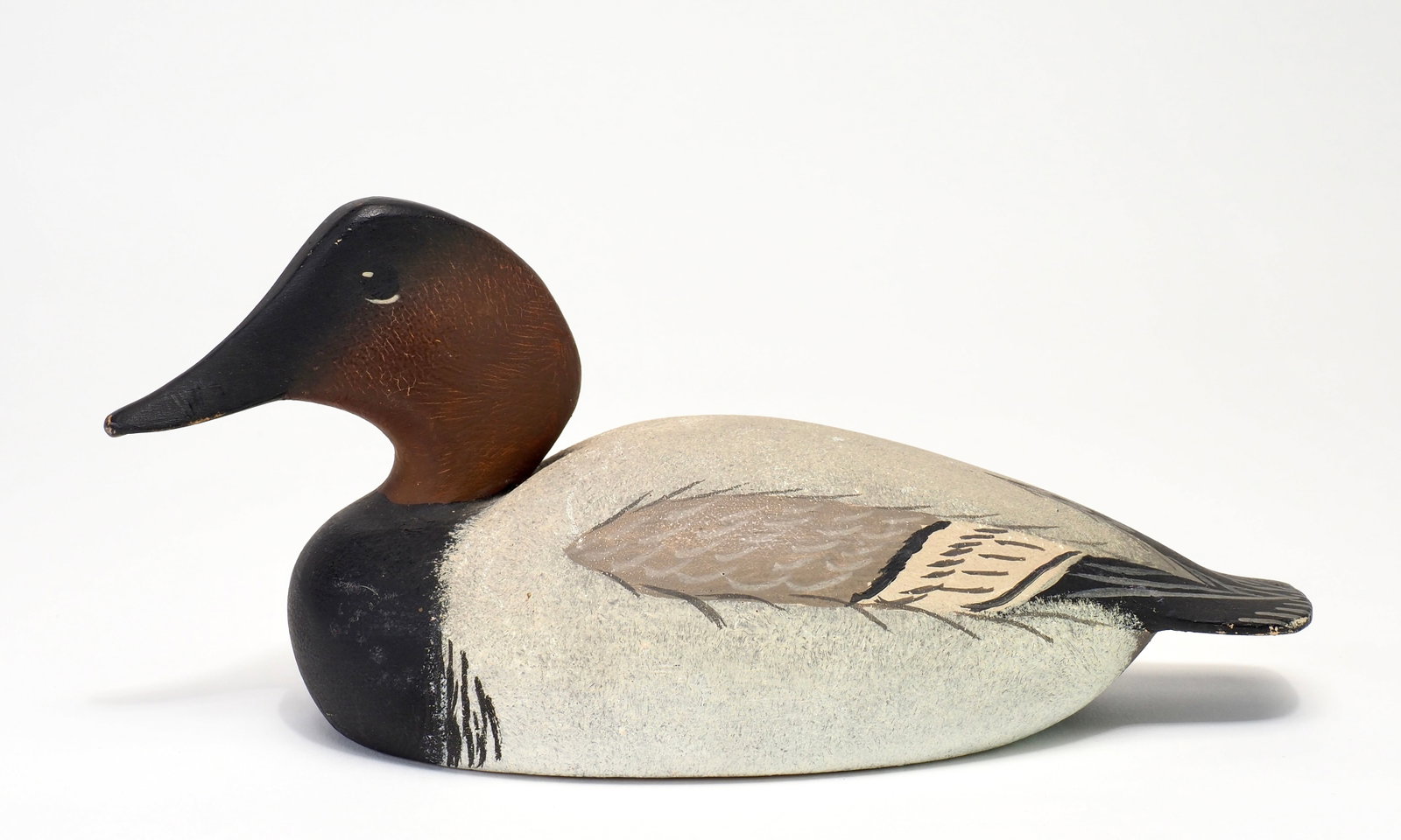 Oliver Lawson - Duck House Miniature Canvasback Drake: Oliver "Tuts" Lawson (b.1938) Crisfield, MD, 1960 8" long Balsa body with cedar tail and head. Slightly turned head and painted eyes. Signed and dated on bottom 1960. Retains original "The Duck