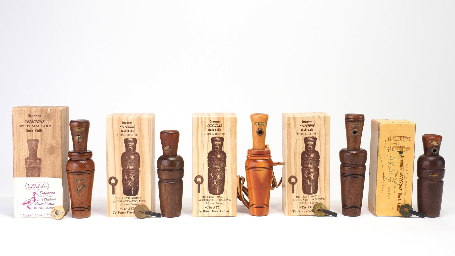 Group of Five Drennen Selectone Duck Calls with Boxes: Walter "Wally" Drennen (1902-1980)De Pue, IL4.25" - 5.5" longMost boxes contain keys, original instructions, some spare parts, and graphics stickers. A mid 1900's Illinois call maker, Walter's