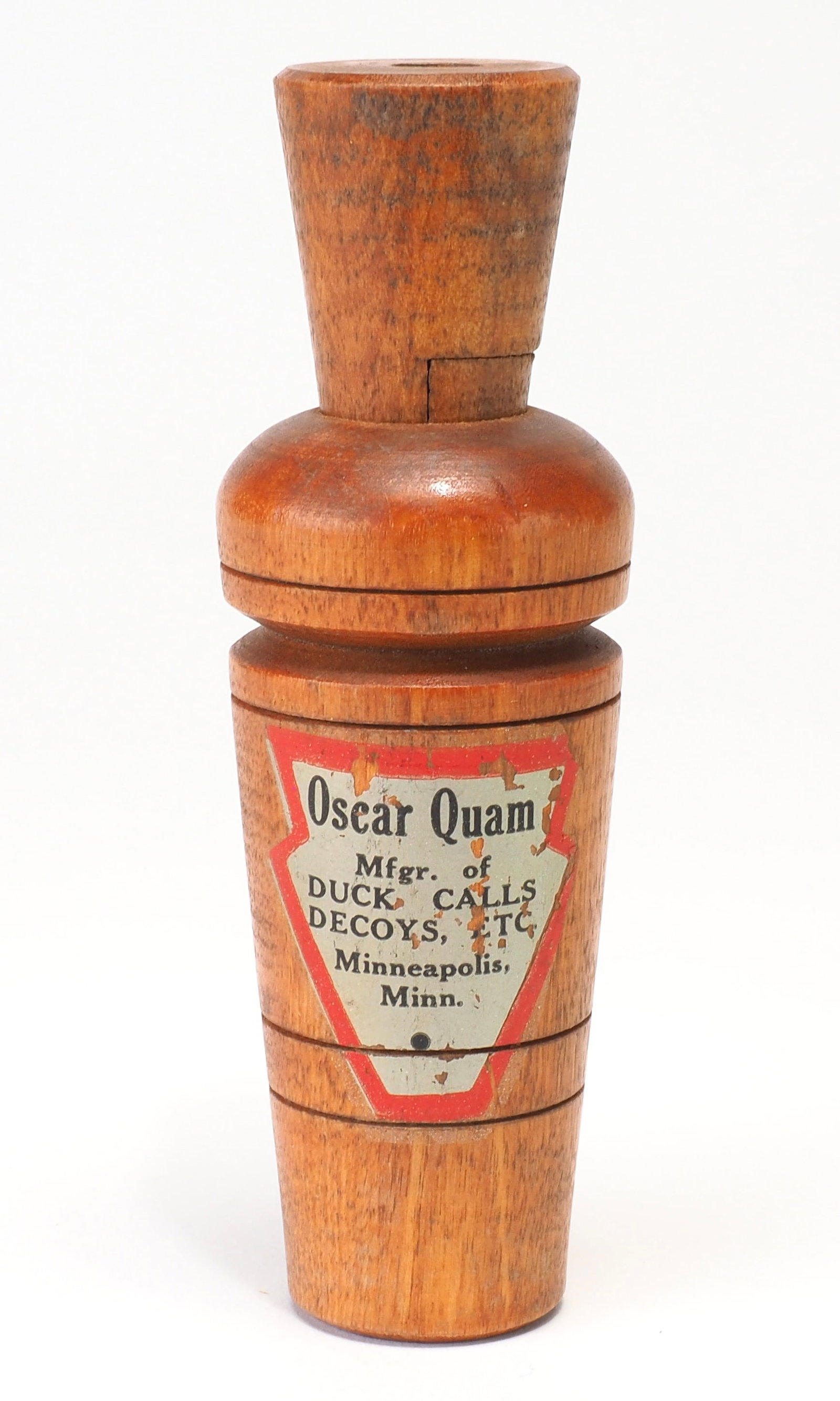 Oscar Quam - Smooth Barrel Red and Silver Duck Call: Oscar Quam (1887-1969) Minneapolis, MN 4.75" long Red and silver Oscar Quam graphic on side of smooth barrel Condition: Good and original with minor wear from use with some loss to graphic