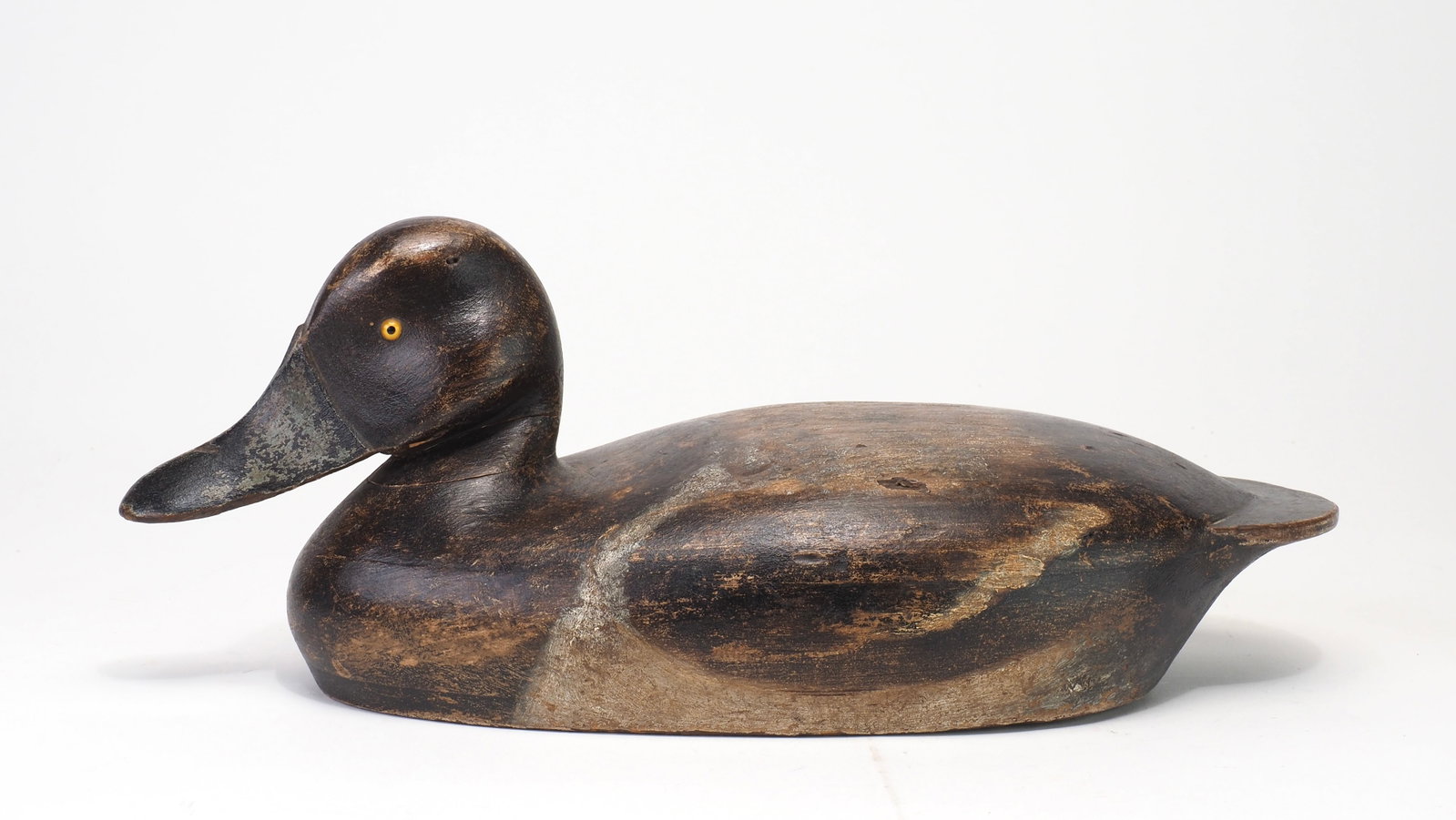 Fritz Geiger - Bluebill Hen: Fritz Geiger (1882-1957) Oshkosh, WI 14" Hollow carved with dramatic bill carving and glass eyes. Head is slightly turned Condition: Appealing working paint with a tight neck crack, some dents and