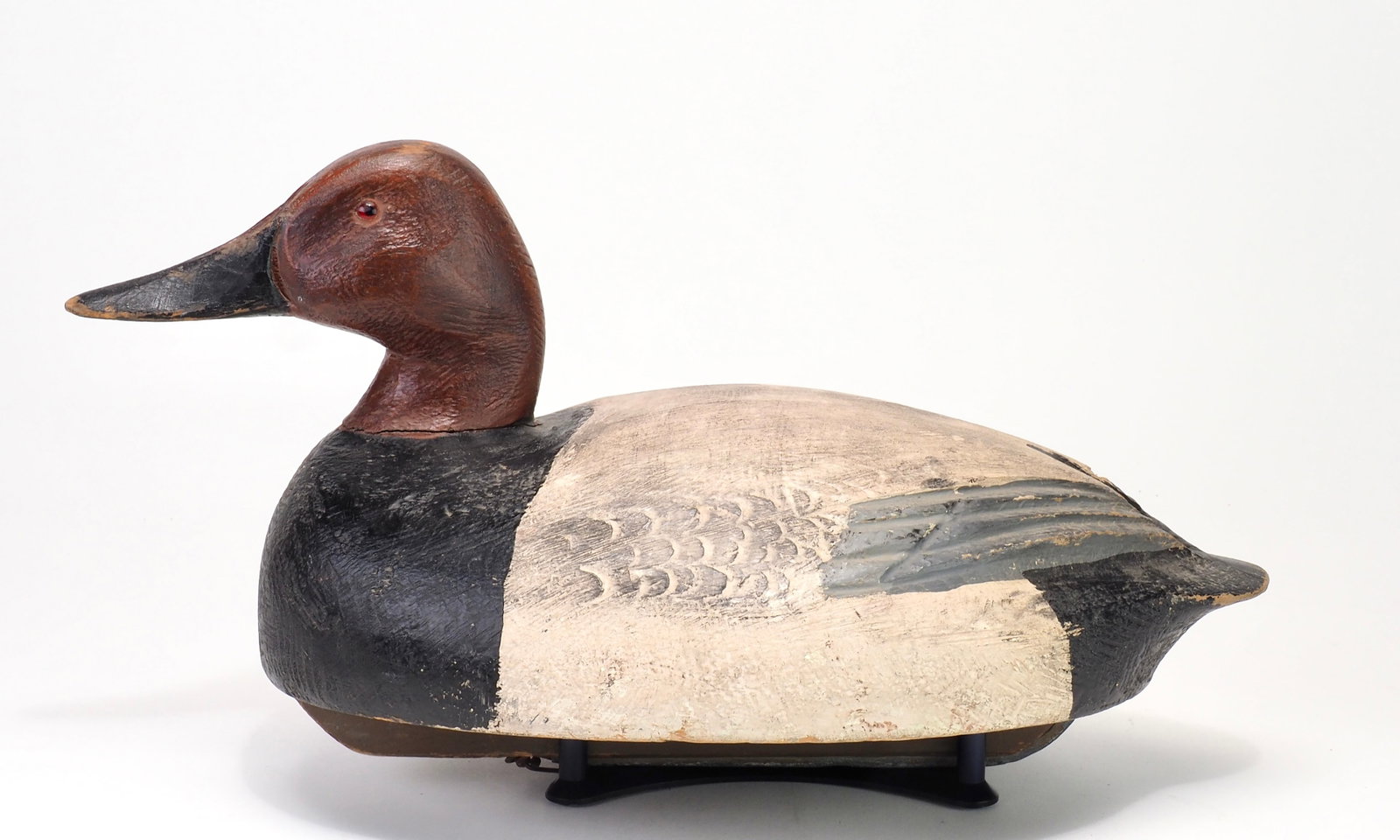 Ben Schmidt - Canvasback Drake: Benjamin S. Schmidt (1884-1968) Centerline, MI 16.25" long Solid body decoy with original keel. Relief carved wing tips on the back with light stamping in front of the speculums. A prominent Michigan 