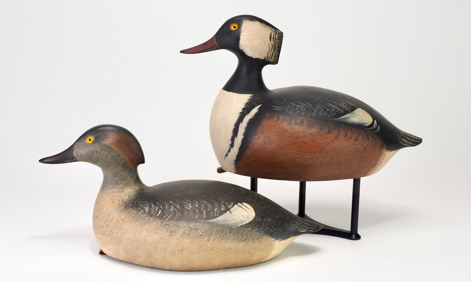 Mike Valley - Hooded Merganser Pair: Mike Valley (b. 1961) Prairie du Chien, WI Drake 13" Hen 13.5" Plump bodied and hollow carved. Both have carved bills and some combed feathering. Signed on bottom Condition: Excellent and original