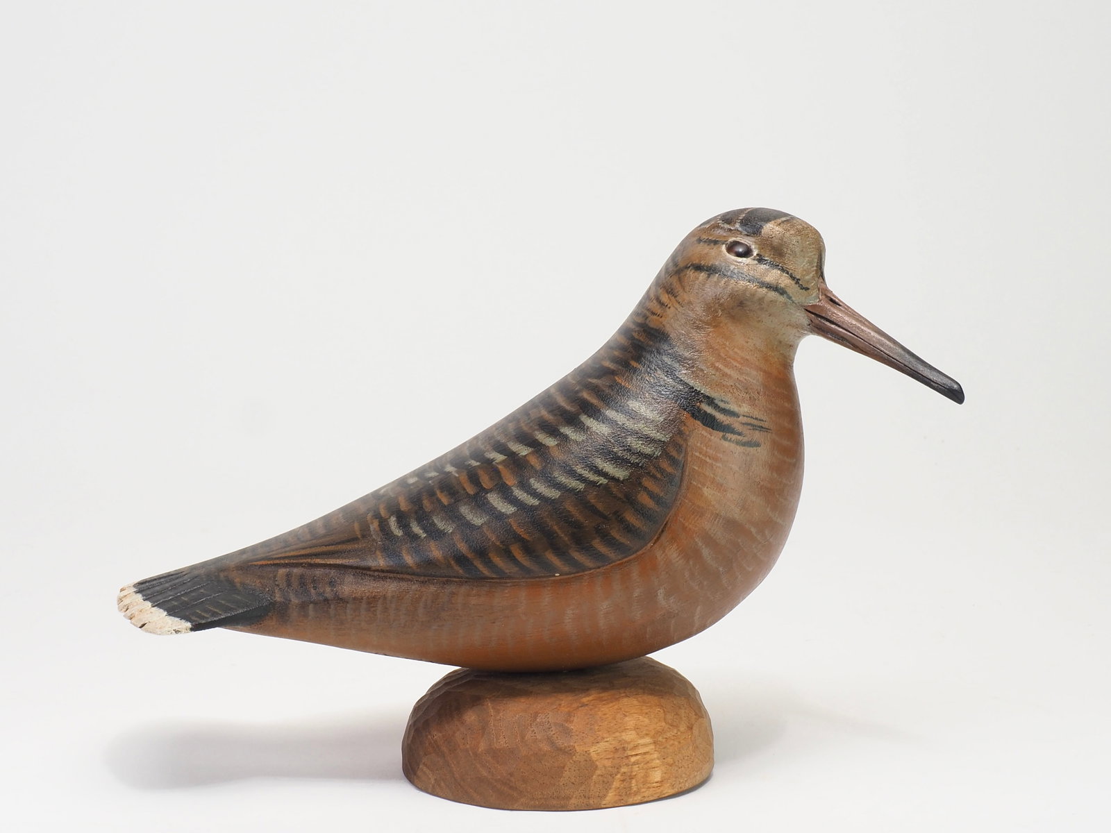 Mike Borrett - Woodcock: Mike Borrett (b. 1960) Madison, WI, 2012 9.75" tall Contentedly resting woodcock mounted on a chip-carved base. Bold feather paint with deeply relief-carved wings sweeping rearward before gracefully
