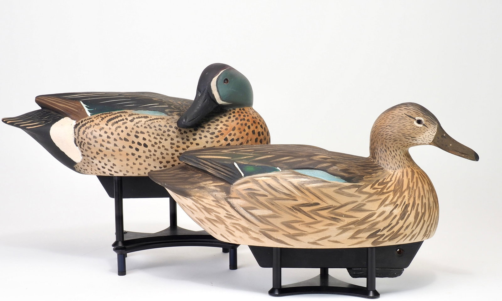 Mike Borrett - Blue Wing Teal Pair: Mike Borrett (b. 1960) Madison, WI 13.5" long Hollow-carved with raised wing points with primary carved feathers. Glass eyes with carved bills and original applied keels. "BORRETT" carved on bottom