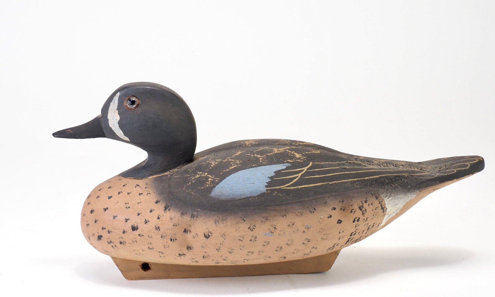 Quogue Wildfowler Decoy Factory - Bluewing Teal Drake: Wildfowler Decoy Factory Quogue, Long Island, NY 11.25" long Sculpted wings with relief carving bill where it meets the face. Original keel partially over the Quogue circle stamp. Condition: Near mint