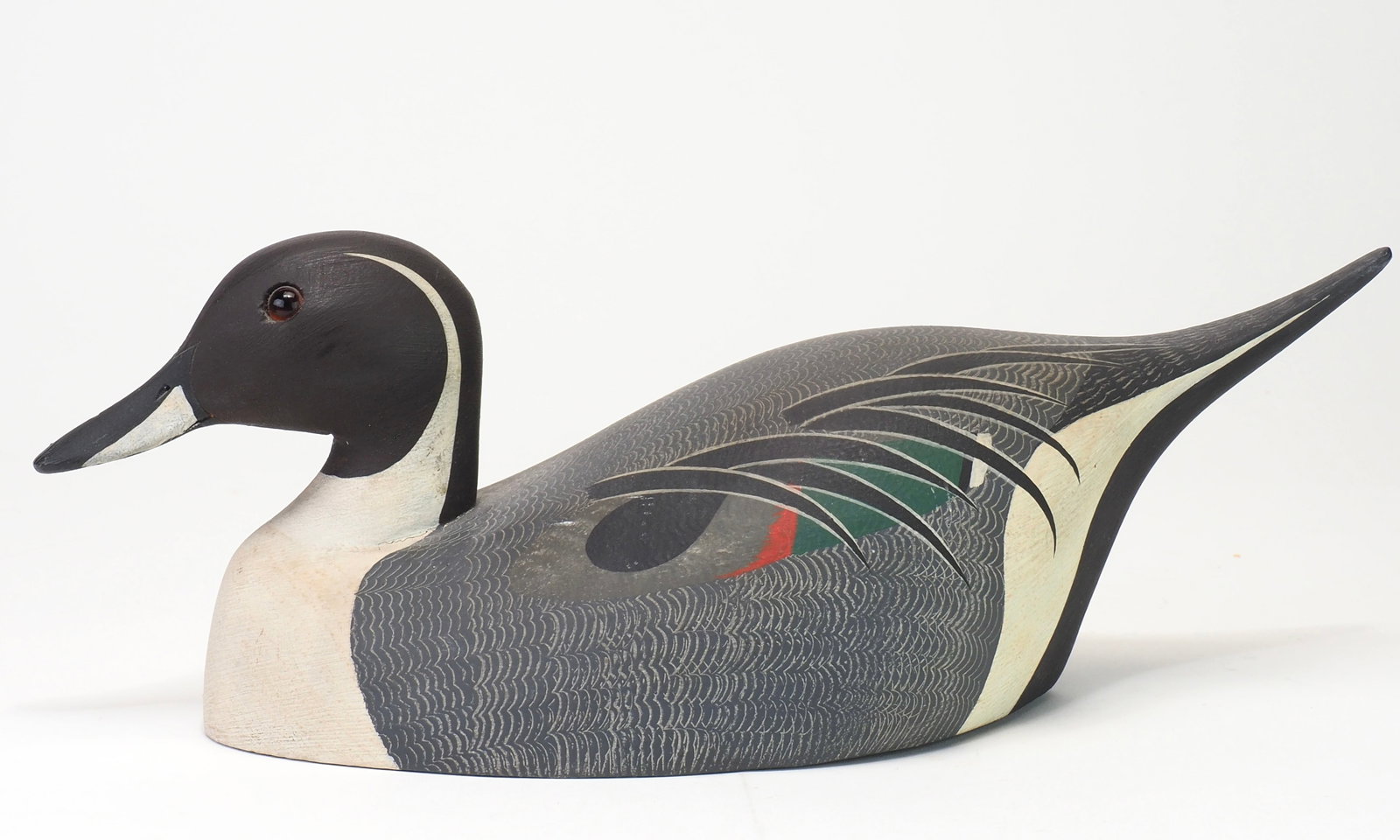 Ken Harris - 2/3 size Pintail Drake: Ken Harris (1905-1981) Woodville, NY 13" long Scratch feathering across the entire body with glass eyes and incised bill details. Ken Harris ink stamp on bottom side. Condition: Excellent and original