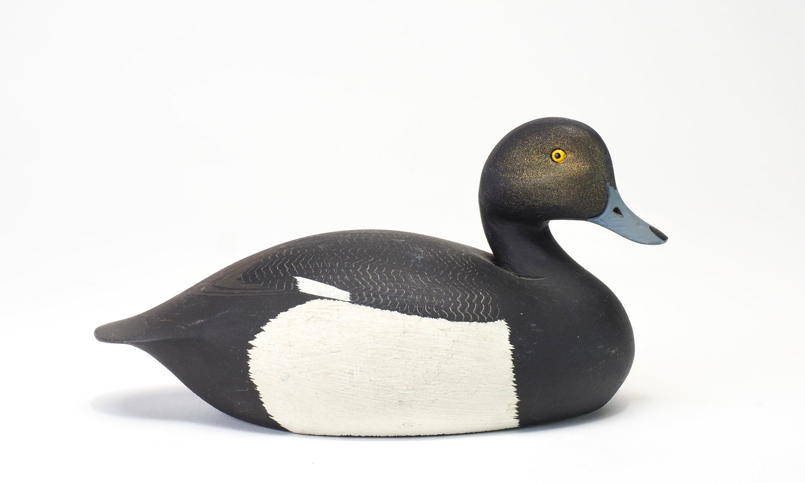 Ken Harris - Miniature Bluebill Drake: Ken Harris (1905-1981) Woodville, NY 6.26" long Alert and slightly turned head with painted eyes and incised bill details. Scratch feathering on the back. White ink stamp on felt bottom Condition: