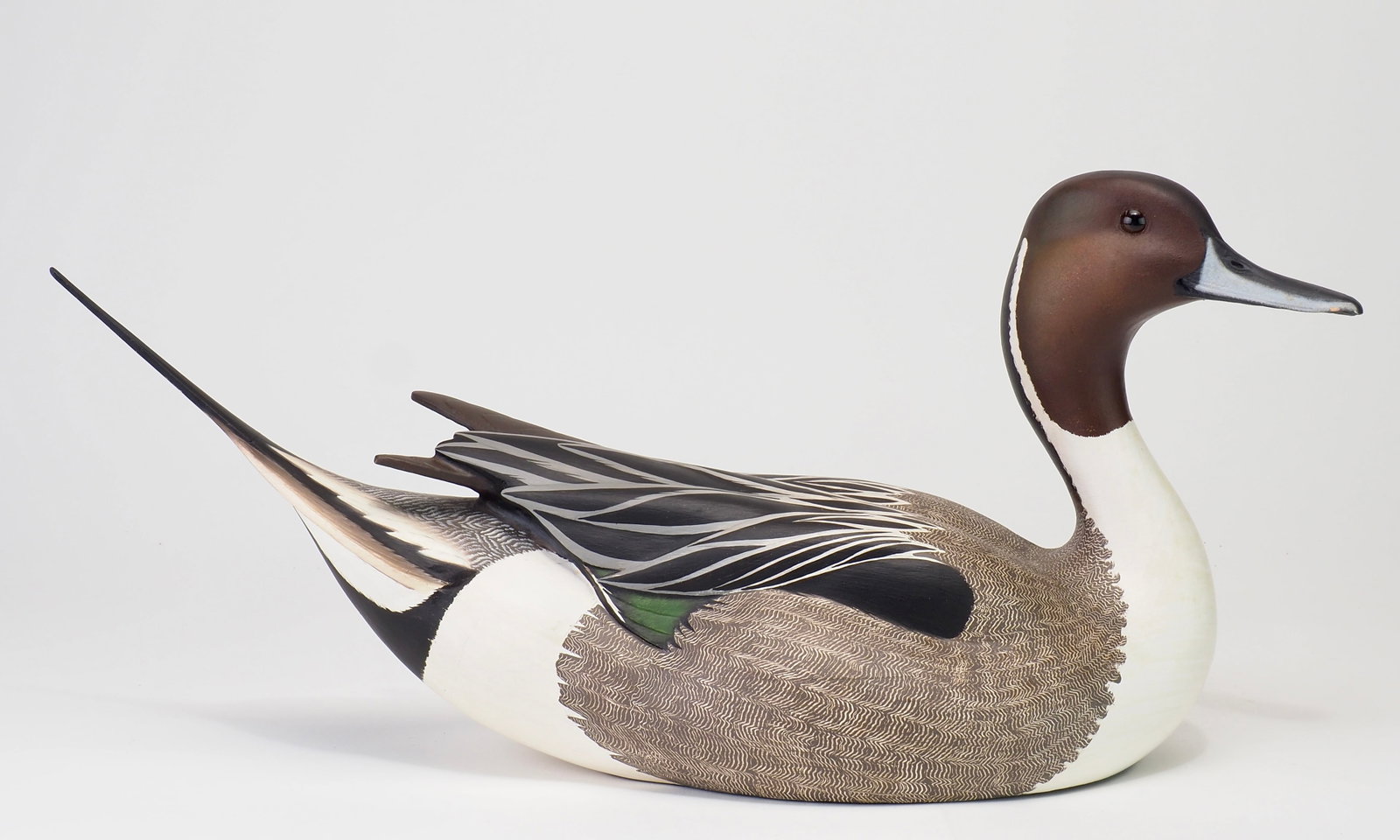 Leo McIntosh - Pintail Drake: Leo McIntosh (1953-2007) Woodville, NY c.1985 17.5" long Exceptionally well sculpted pintail drake with a thin upswept sprig tail and raised crossed wing tips. Raised head turned off to the right with