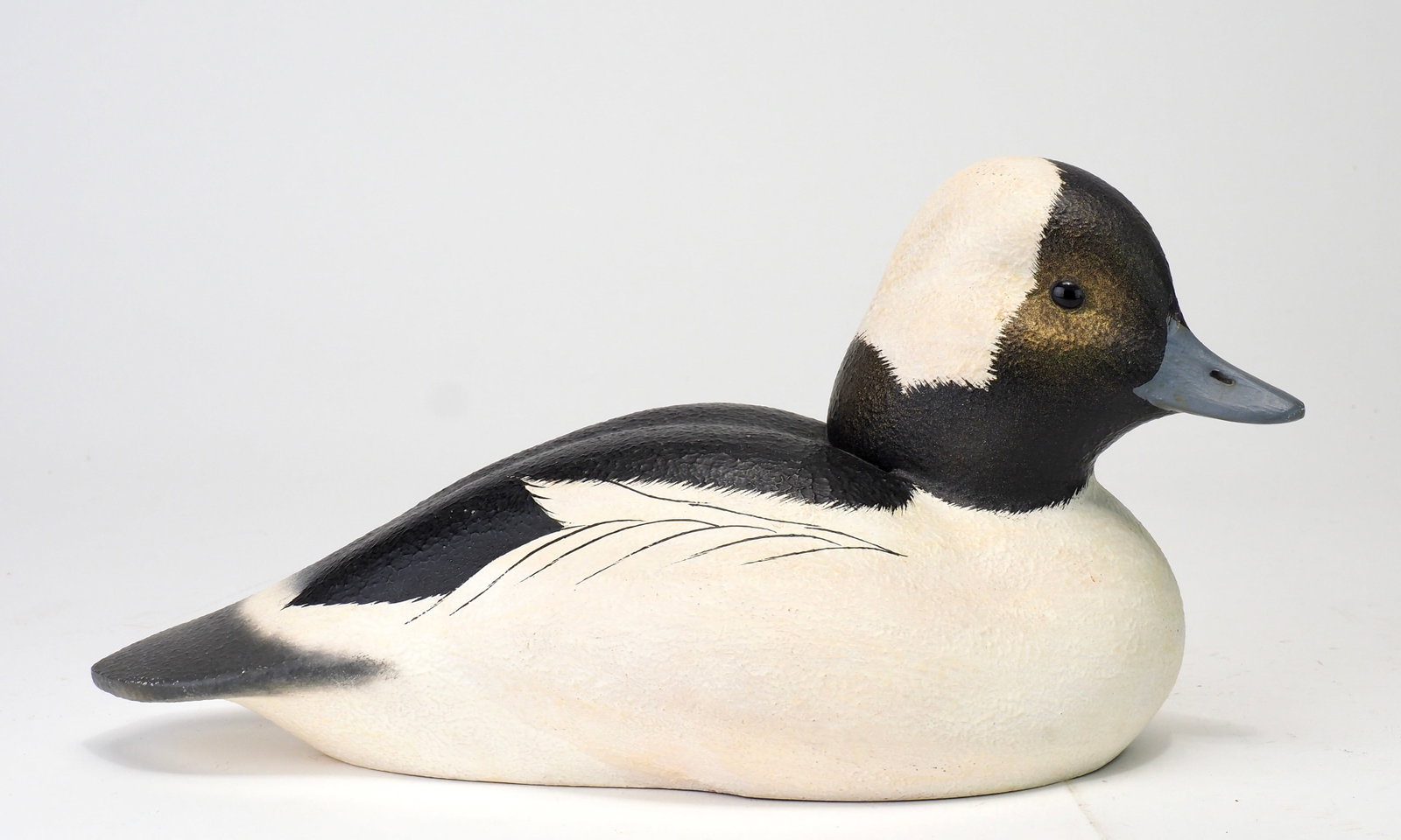 Leo McIntosh - Hollow Bufflehead Drake: Leo McIntosh (1953-2007) Woodville, NY, 1983 10" Signed and dated 1983, hollow carved with a textured surface. Well sculpted in a content posture with the head gently turned off to the right. Leo
