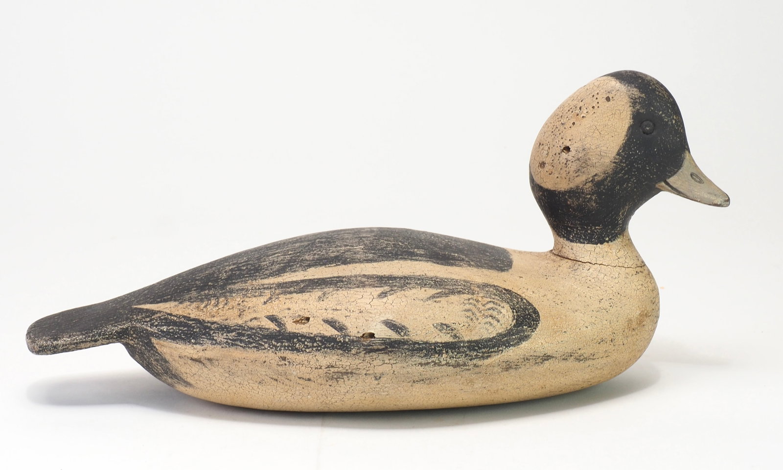 Leo McIntosh - Antiqued Stevens Stle Bufflehead Drake: Leo McIntosh (1953-2007) Woodville, NY 11" long Observing the styles of his peers Mark McNair, David Ward, and Bob White, McIntosh ventured into 'antiqued' style decoys. Sometimes taking perfectly